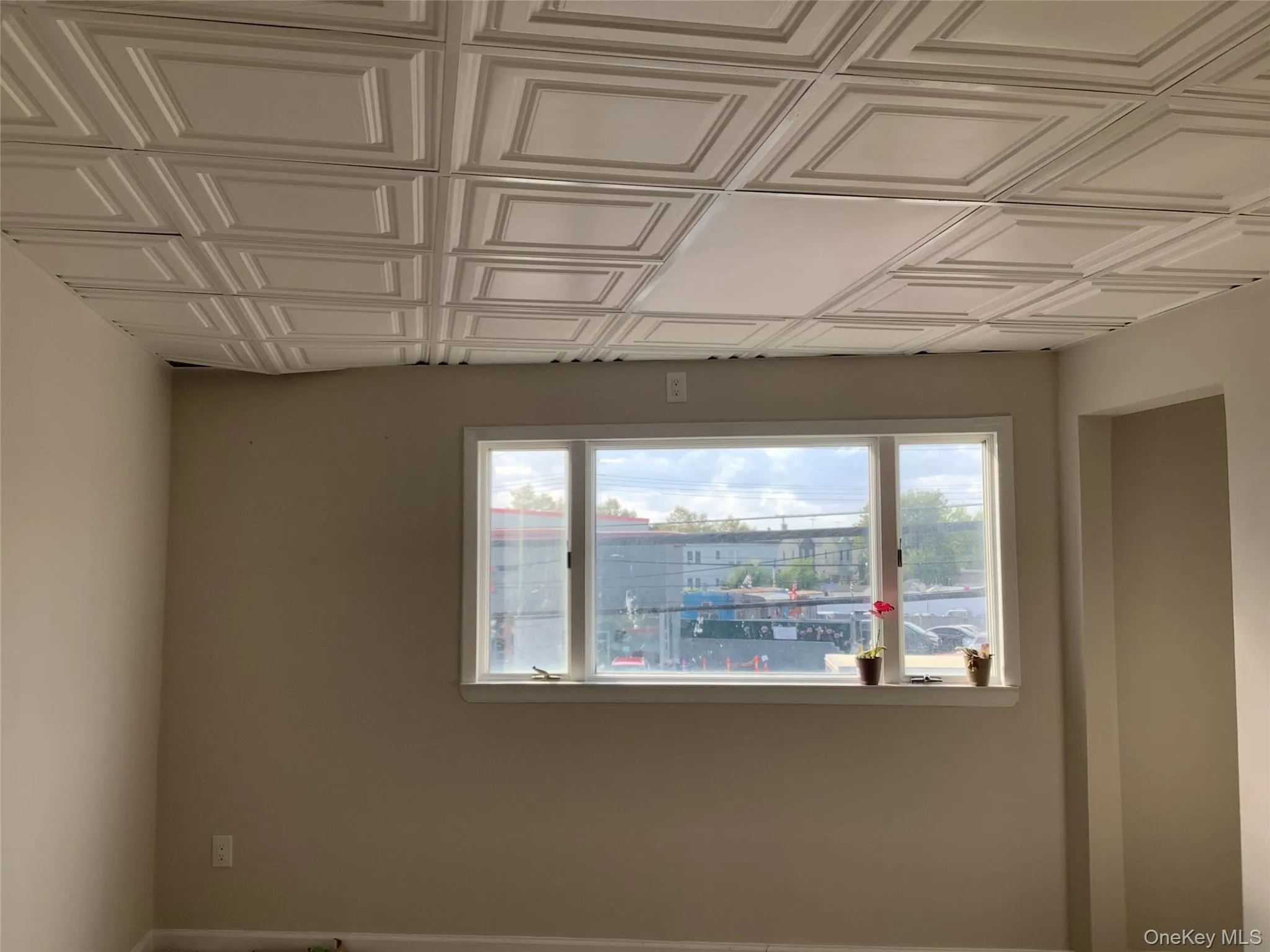 Unfurnished room with plenty of natural light and an ornate ceiling Unfurnished room with plenty of natural light and an ornate ceiling