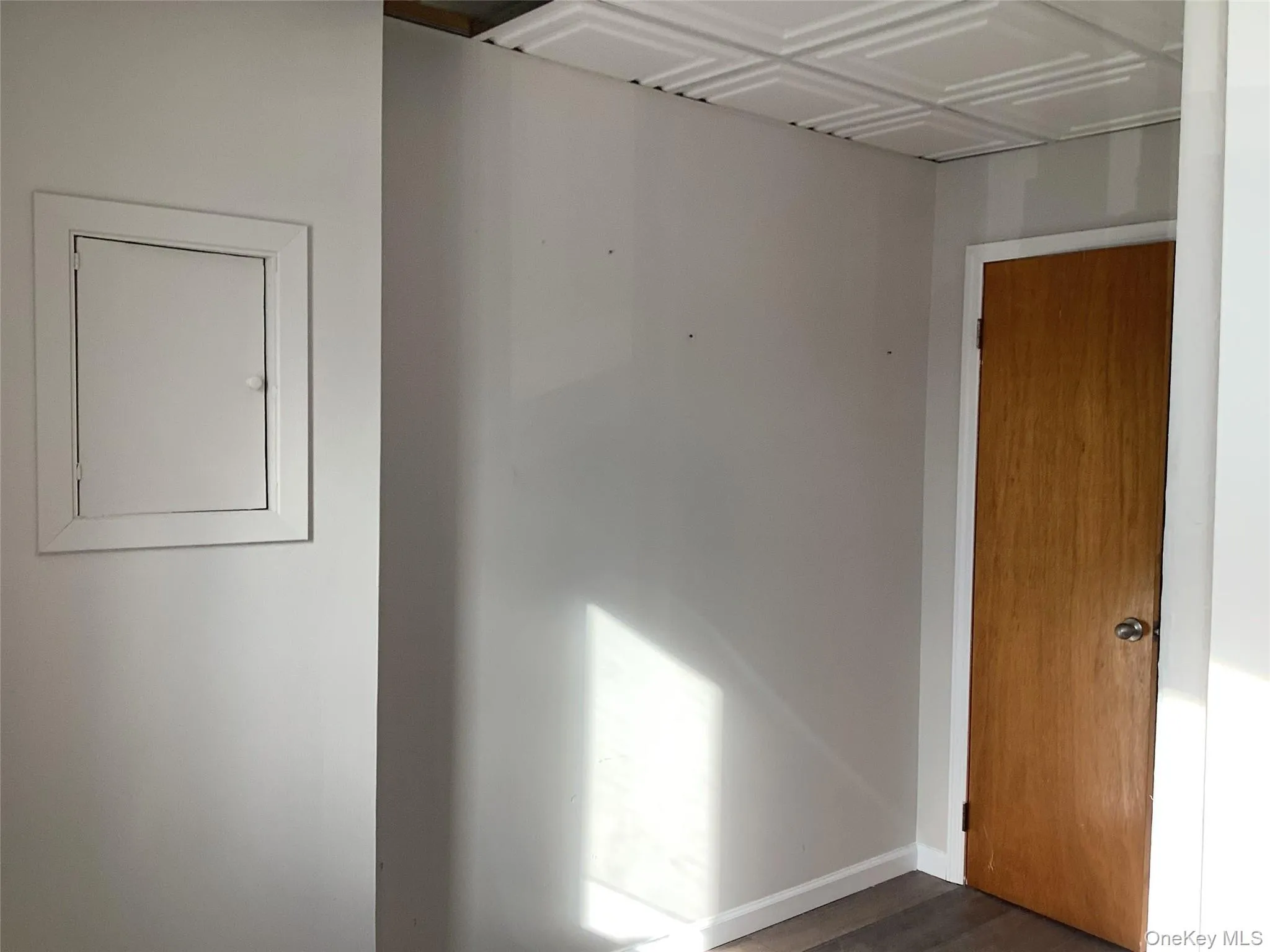 Empty room featuring baseboards and dark wood-style floors Empty room featuring baseboards and dark wood-style floors