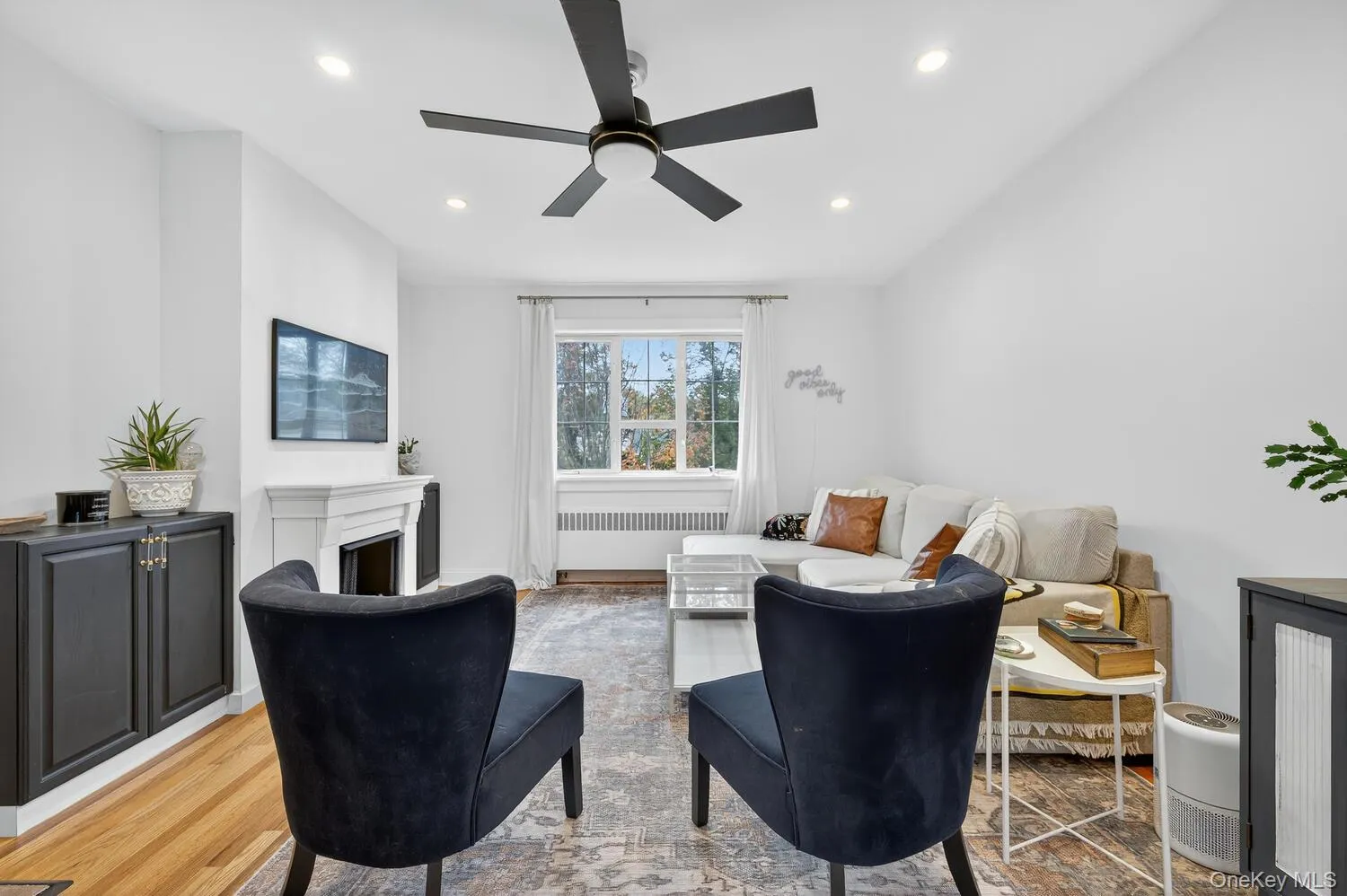 Sitting room with a, radiator, recessed lighting, and wood finished floors Sitting room with a, radiator, recessed lighting, and wood finished floors