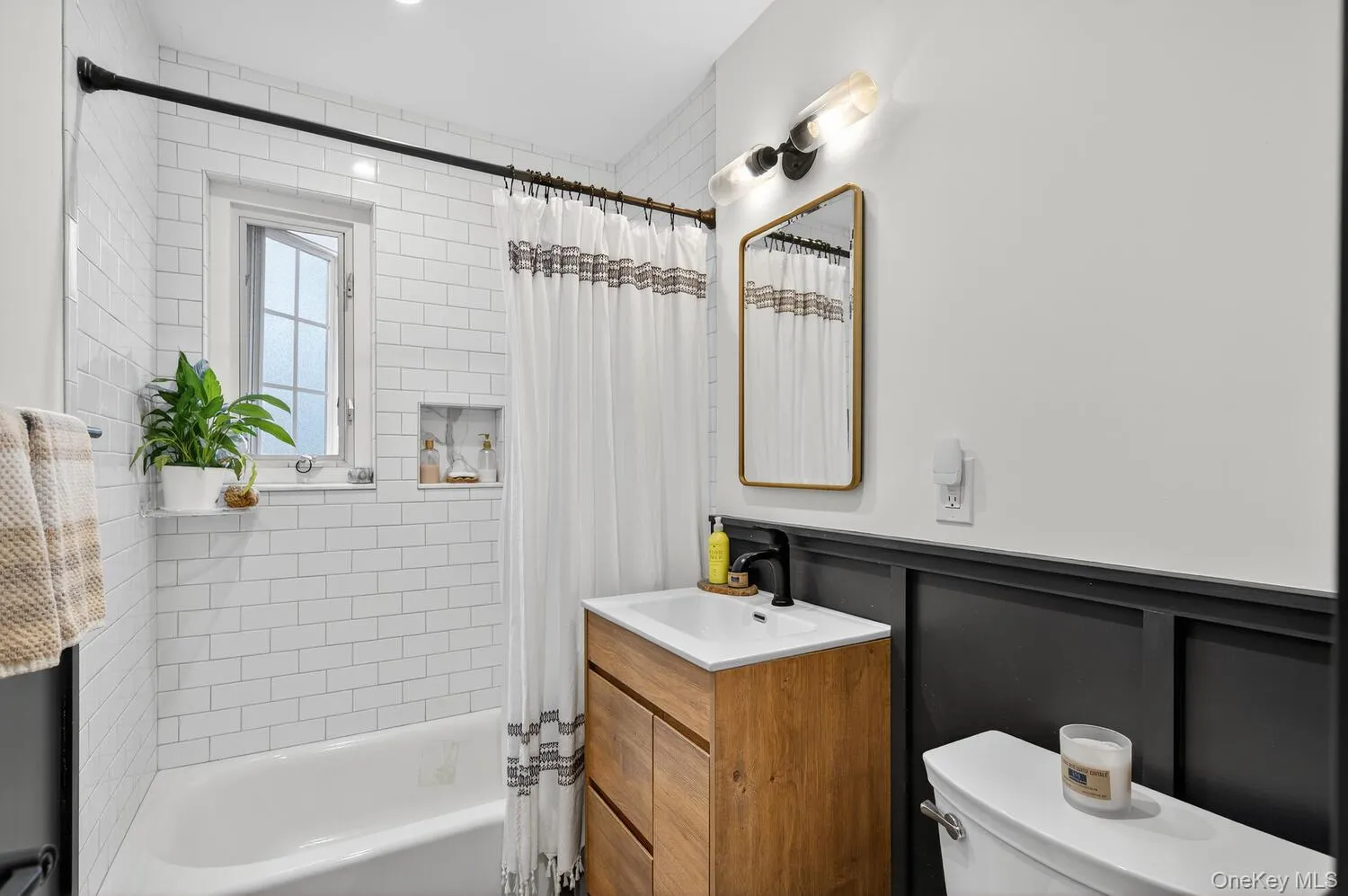 Bathroom featuring shower / bath combo and vanity Bathroom featuring shower / bath combo and vanity