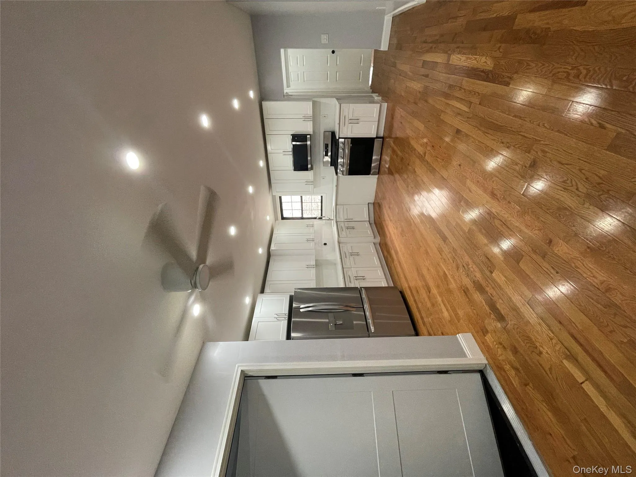 Kitchen with white cabinets, fridge, stove, recessed lighting, and light wood finished floors Kitchen with white cabinets, fridge, stove, recessed lighting, and light wood finished floors