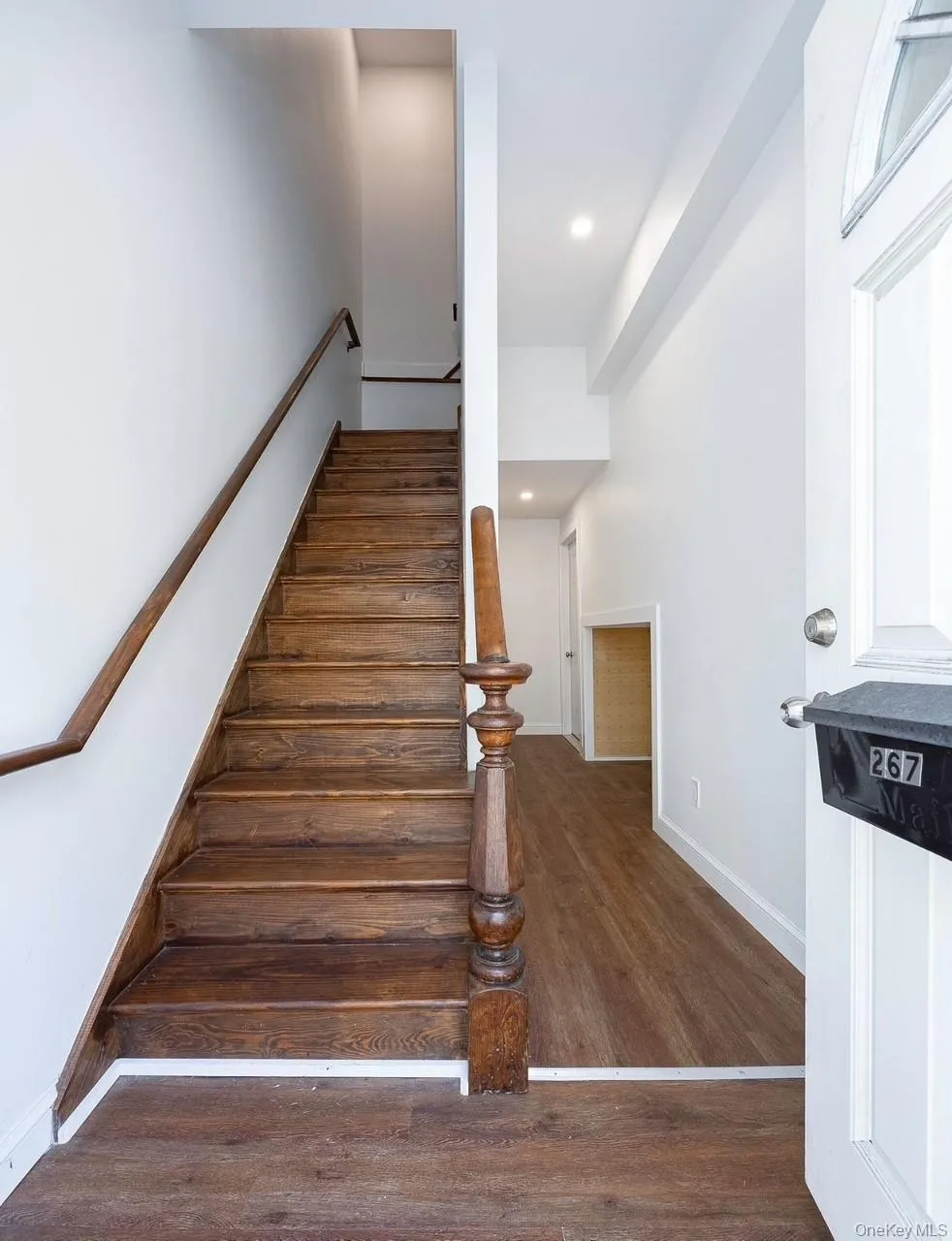 Stairs featuring wood finished floors and recessed lighting Stairs featuring wood finished floors and recessed lighting
