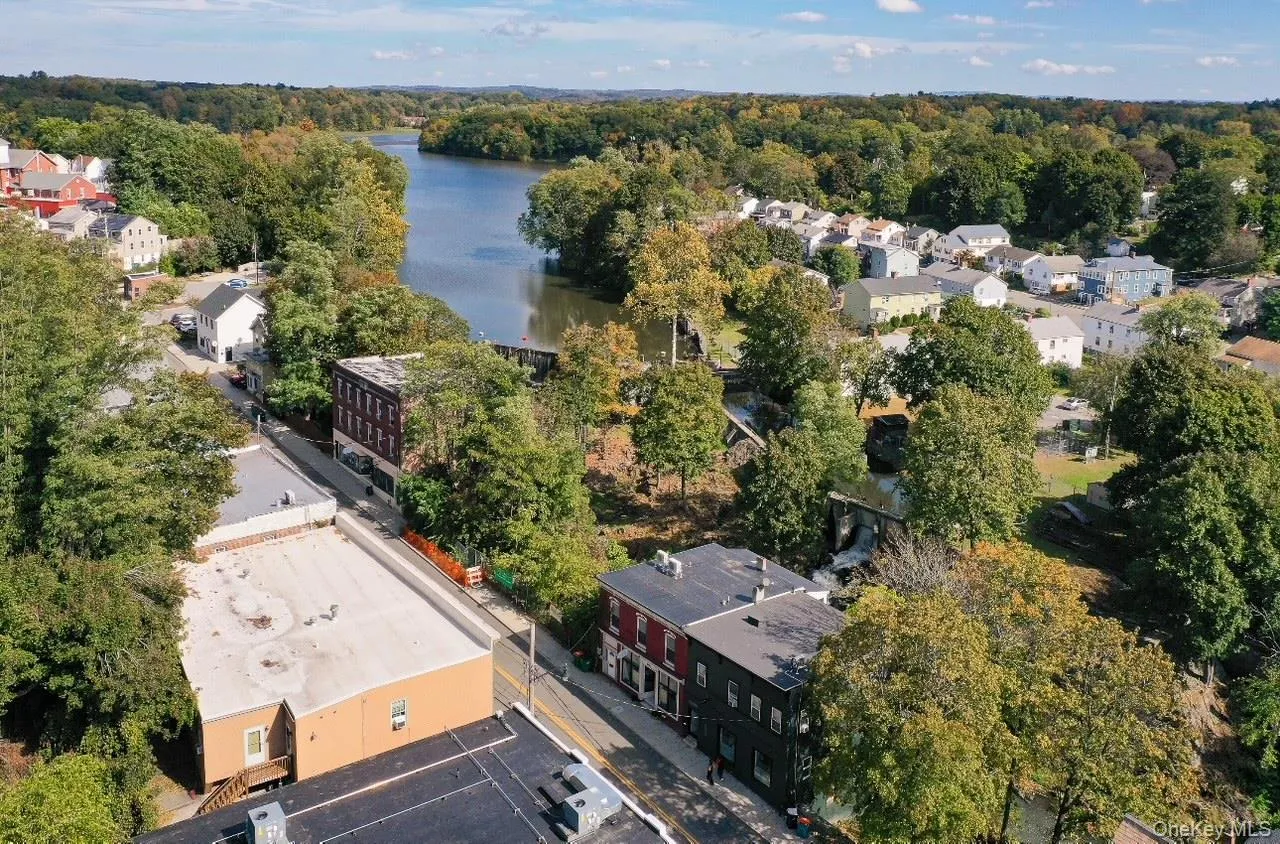 Aerial view of residential area featuring a nearby body of water Aerial view of residential area featuring a nearby body of water