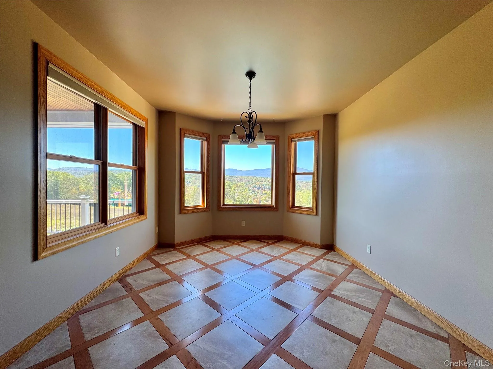 Unfurnished dining area featuring baseboards and a chandelier Unfurnished dining area featuring baseboards and a chandelier