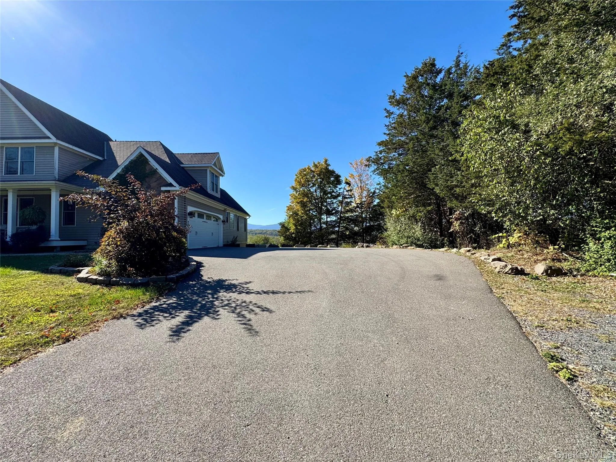 View of home's exterior with asphalt driveway and a garage View of home's exterior with asphalt driveway and a garage