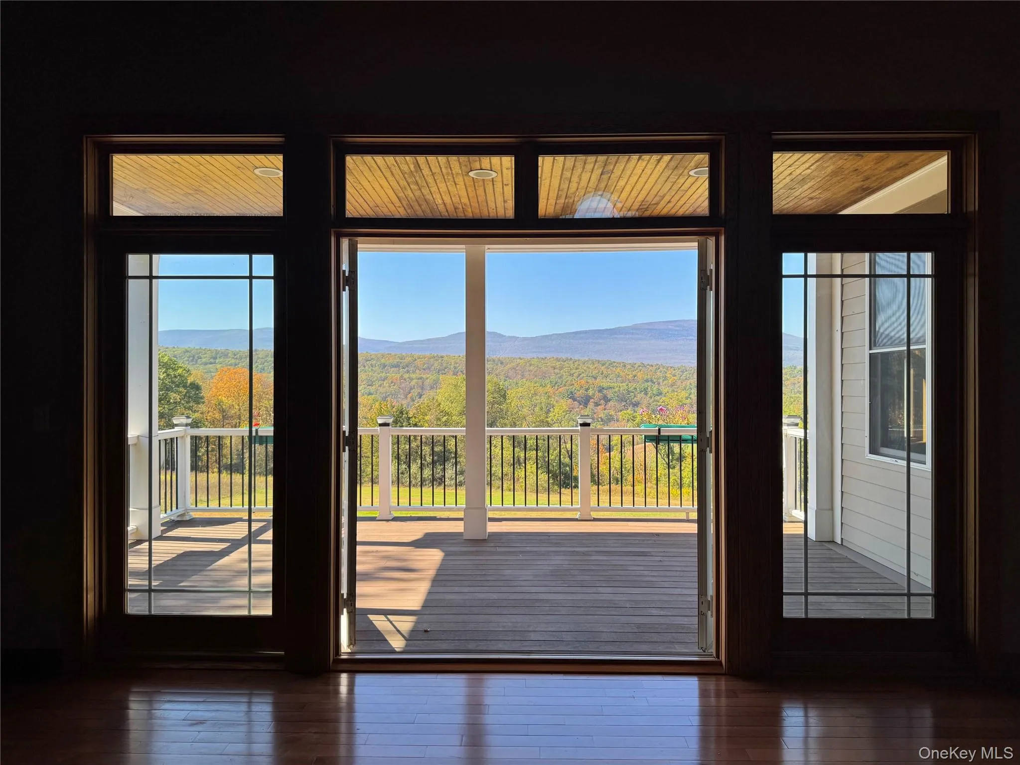 Entryway with a mountain view, a view of trees, and wood-type flooring Entryway with a mountain view, a view of trees, and wood-type flooring