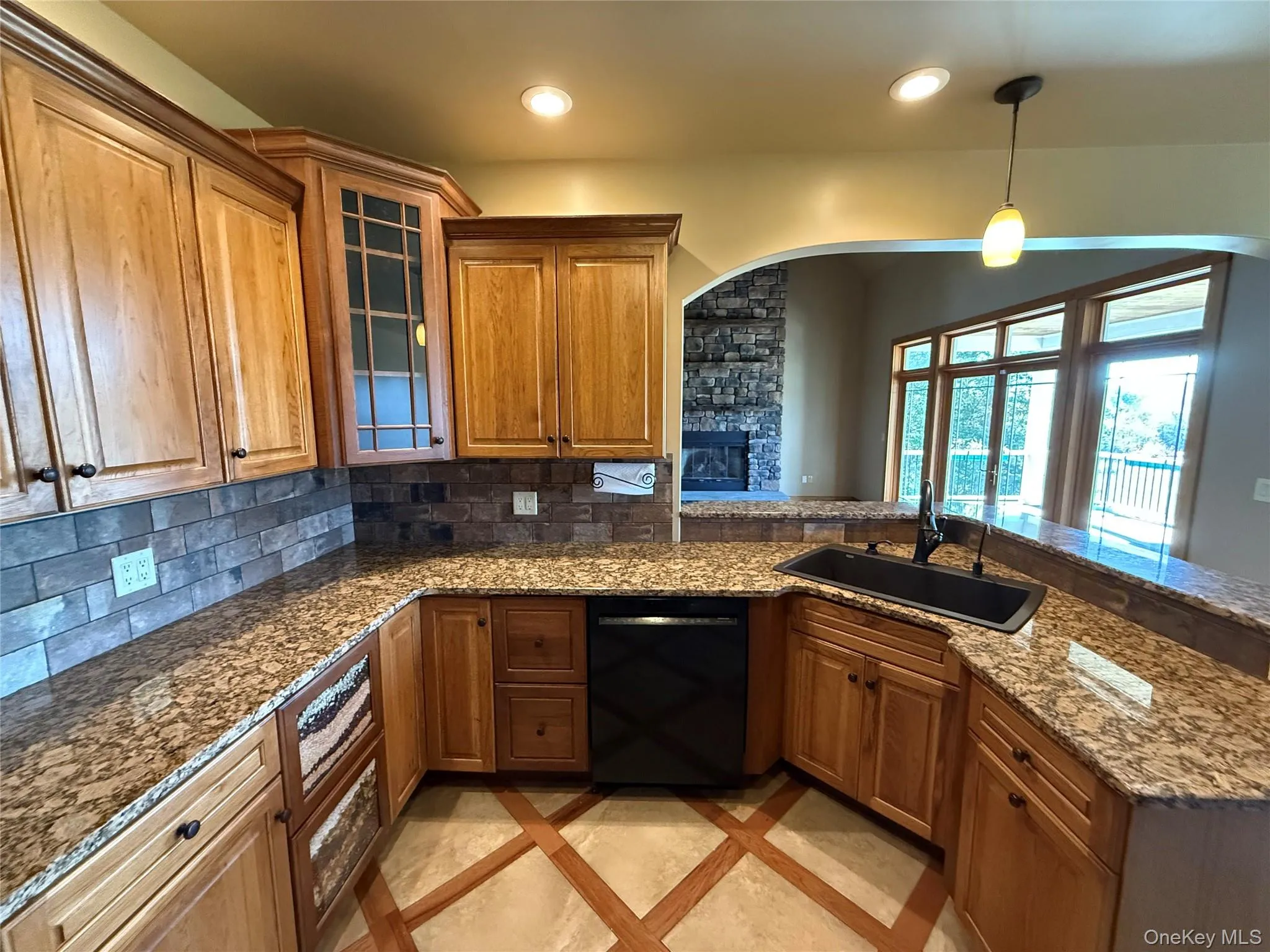 Kitchen featuring brown cabinetry, backsplash, and recessed lighting Kitchen featuring brown cabinetry, backsplash, and recessed lighting