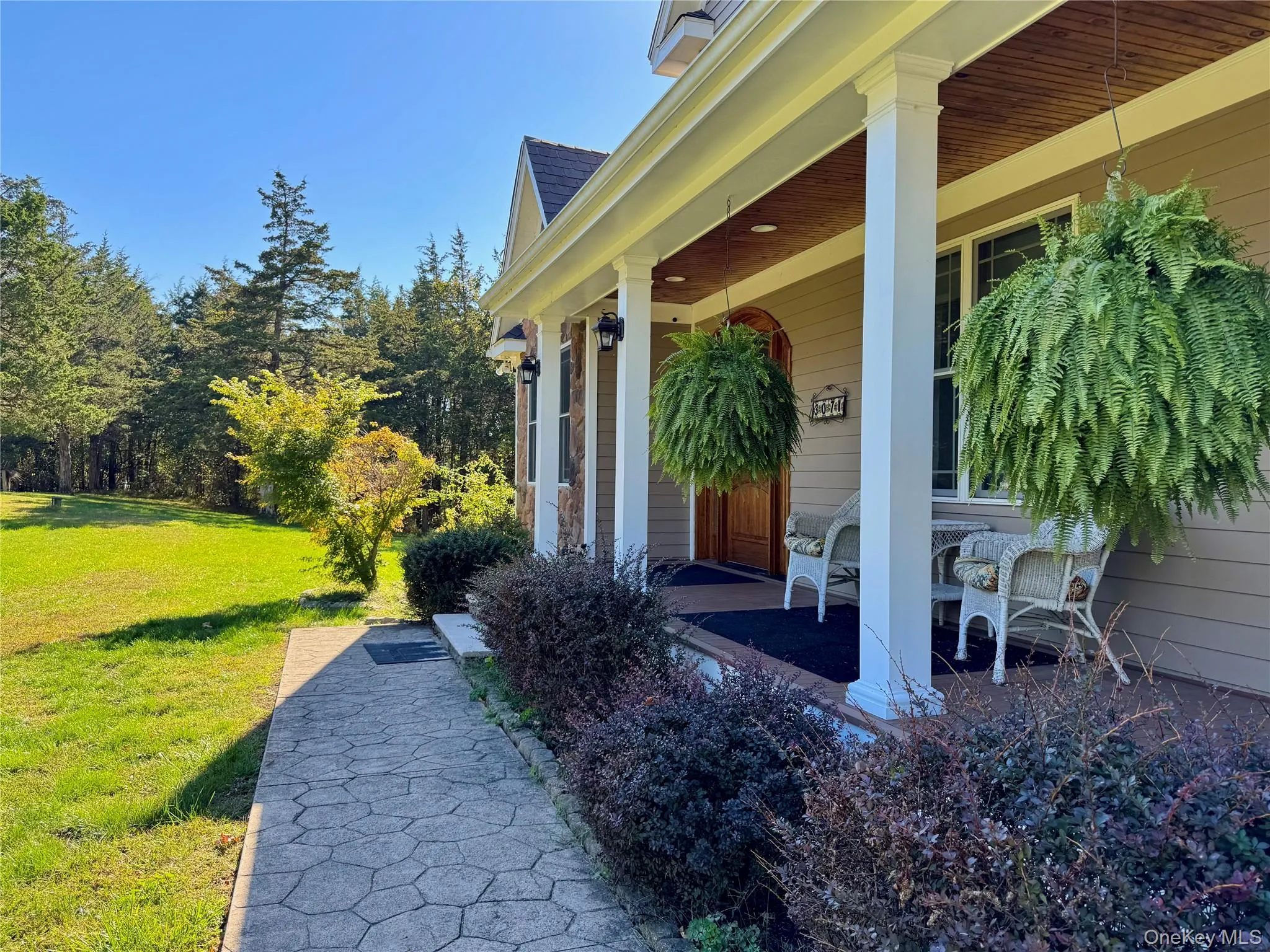 Entrance to property with a lawn and covered porch Entrance to property with a lawn and covered porch