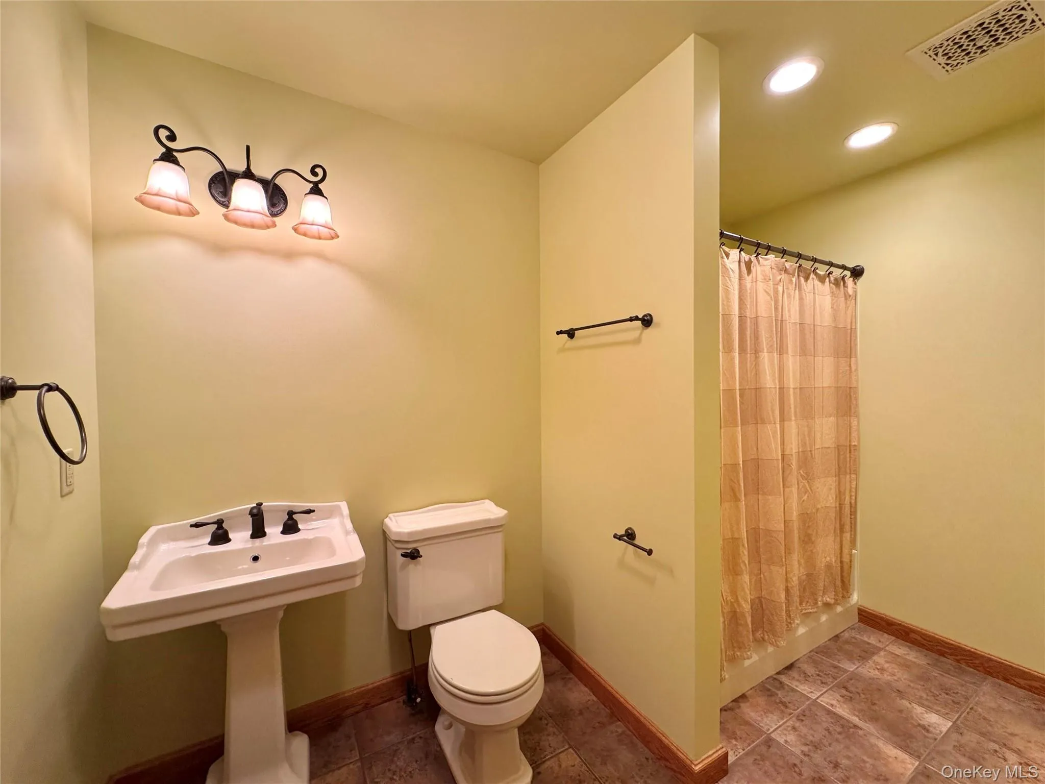 Full bathroom with curtained shower, recessed lighting, and tile patterned flooring Full bathroom with curtained shower, recessed lighting, and tile patterned flooring