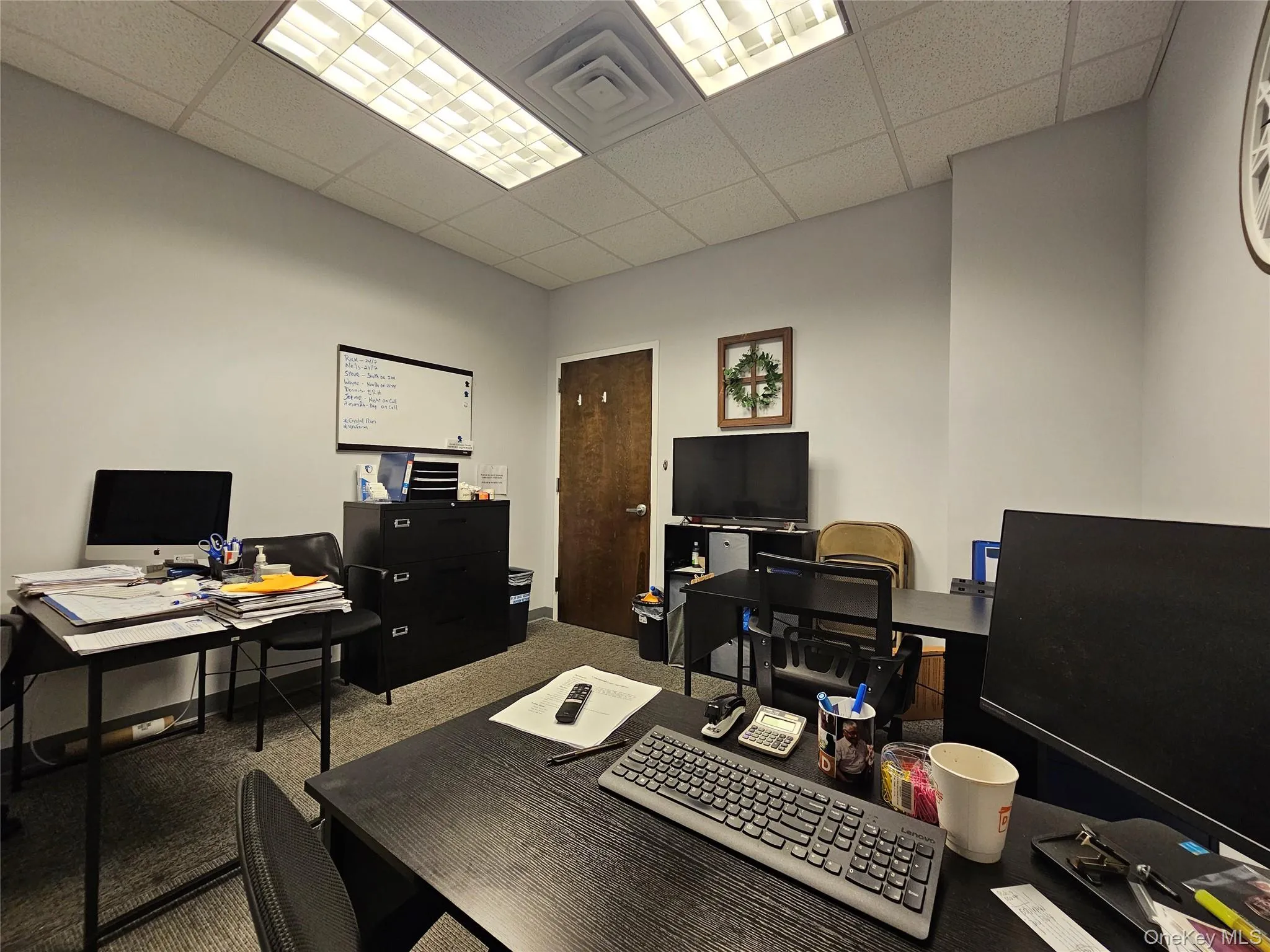 Carpeted office space with a paneled ceiling Carpeted office space with a paneled ceiling