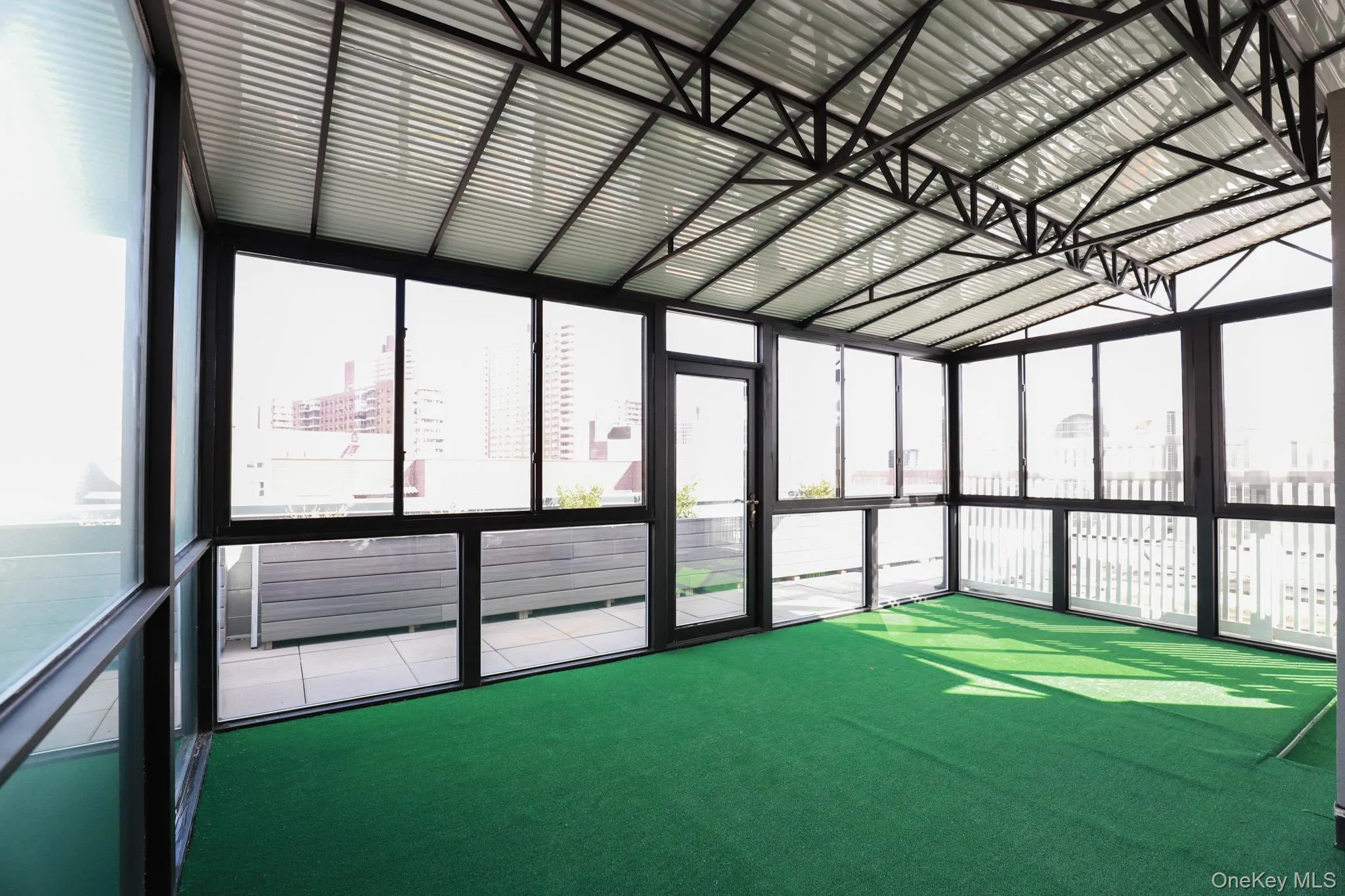 Unfurnished sunroom with a view of city Unfurnished sunroom with a view of city