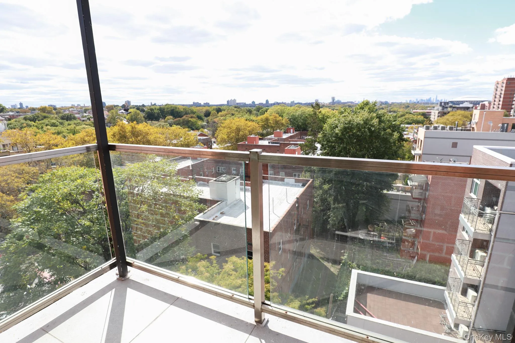 Balcony featuring a view of city and view of wooded area Balcony featuring a view of city and view of wooded area