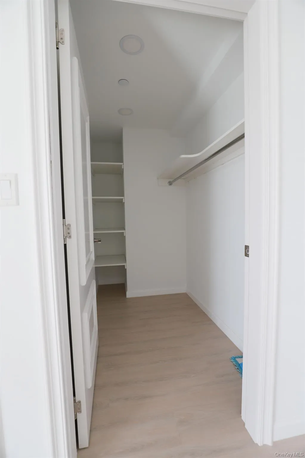 Spacious closet with light wood finished floors Spacious closet with light wood finished floors
