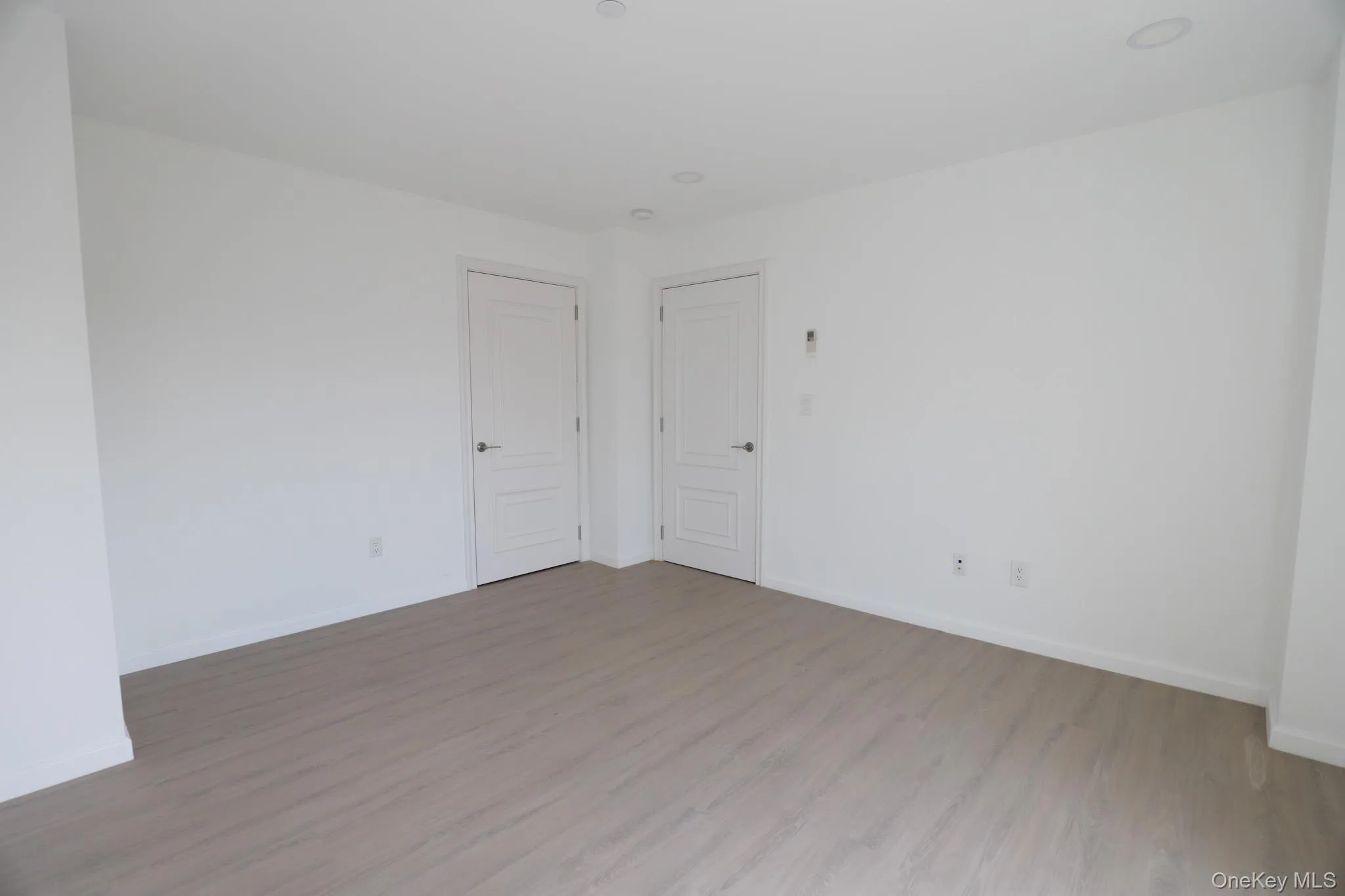 Spare room with wood finished floors and baseboards Spare room with wood finished floors and baseboards