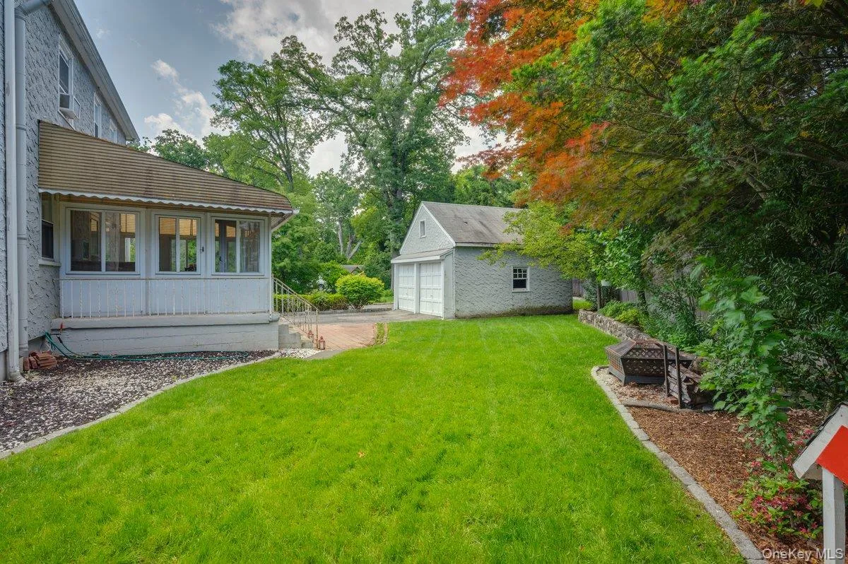 View of yard with a detached garage, parking for one car included View of yard with a detached garage, parking for one car included