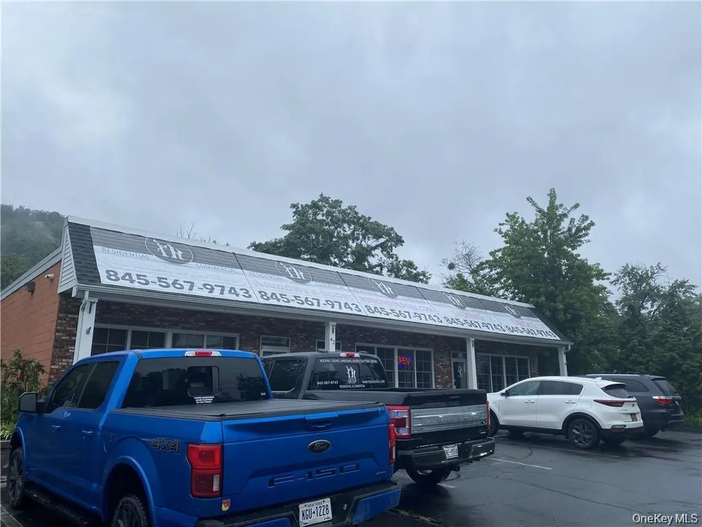 View of building exterior with uncovered parking View of building exterior with uncovered parking