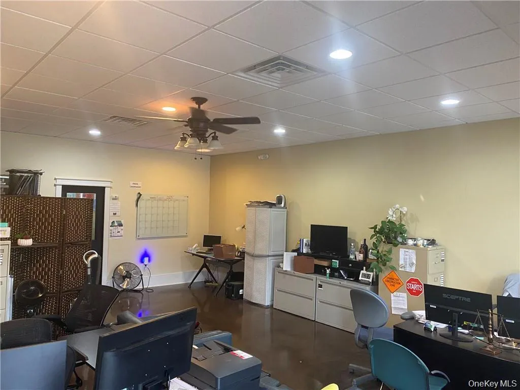 Office area with a ceiling fan, a paneled ceiling, and recessed lighting Office area with a ceiling fan, a paneled ceiling, and recessed lighting