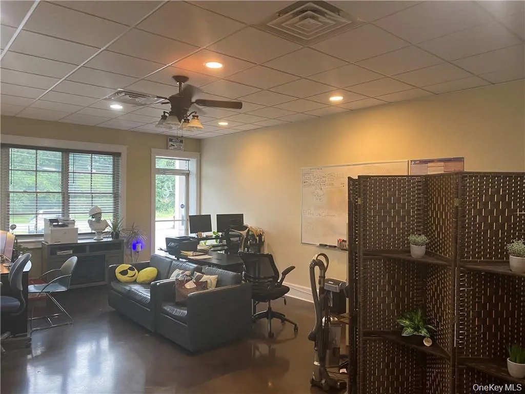 Office space with a drop ceiling, ceiling fan, and recessed lighting Office space with a drop ceiling, ceiling fan, and recessed lighting