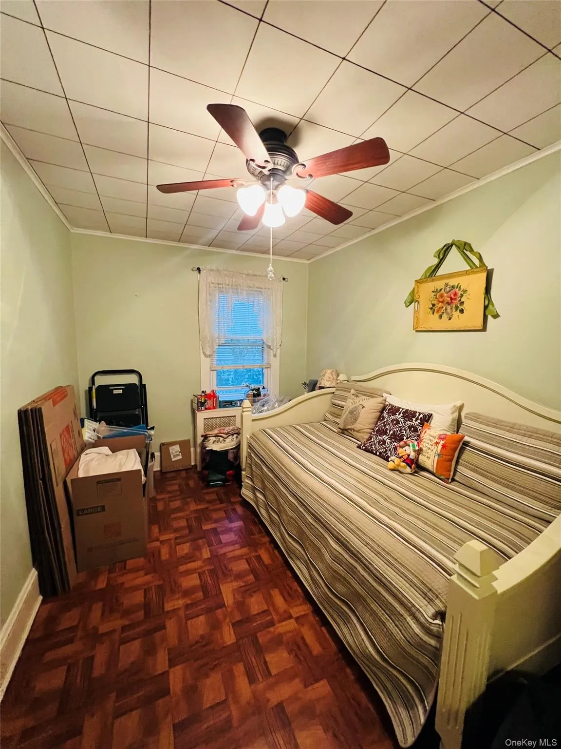 Bedroom featuring a ceiling fan and ornamental molding Bedroom featuring a ceiling fan and ornamental molding