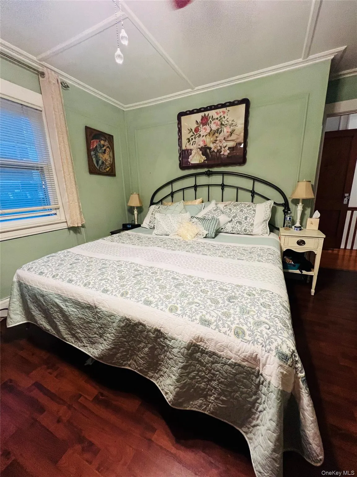 Bedroom with dark wood-type flooring and crown molding Bedroom with dark wood-type flooring and crown molding