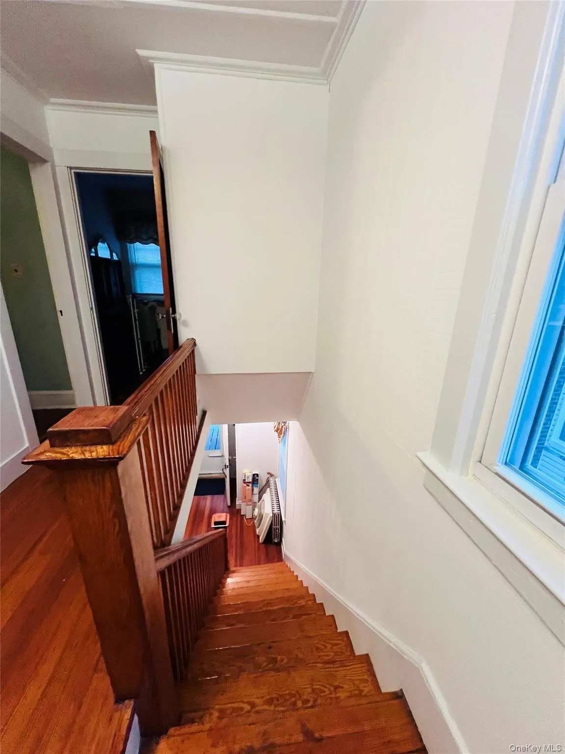 Stairway with wood finished floors and crown molding Stairway with wood finished floors and crown molding
