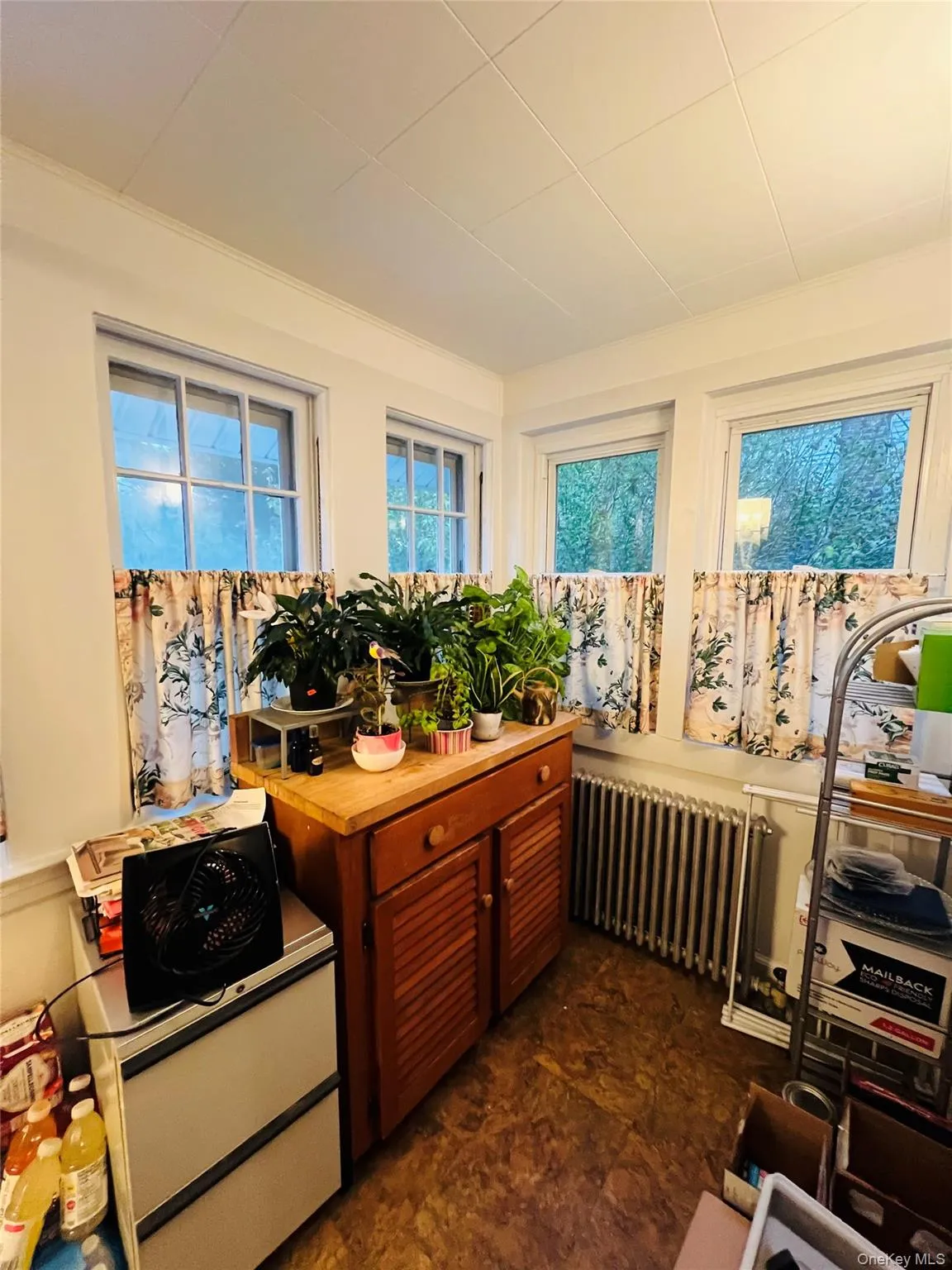 Kitchen featuring radiator and brown cabinets Kitchen featuring radiator and brown cabinets