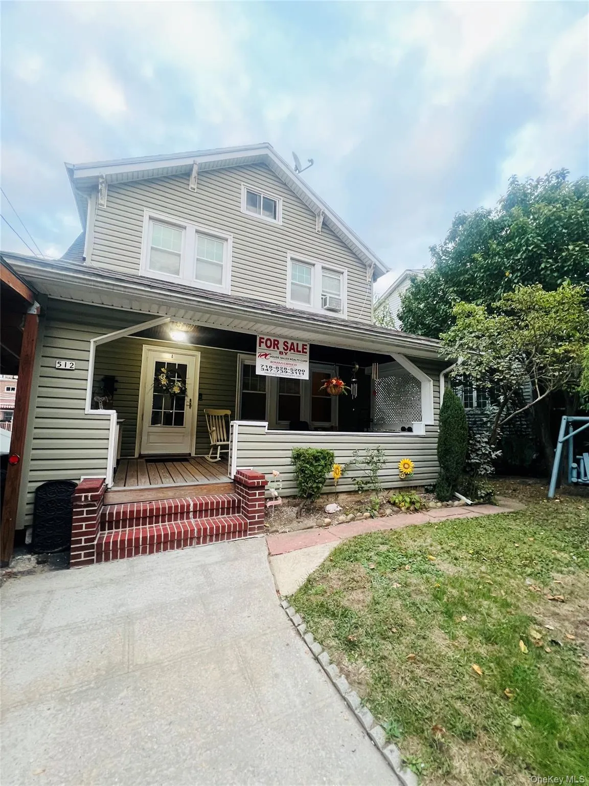 View of front of house with covered porch and a front lawn View of front of house with covered porch and a front lawn