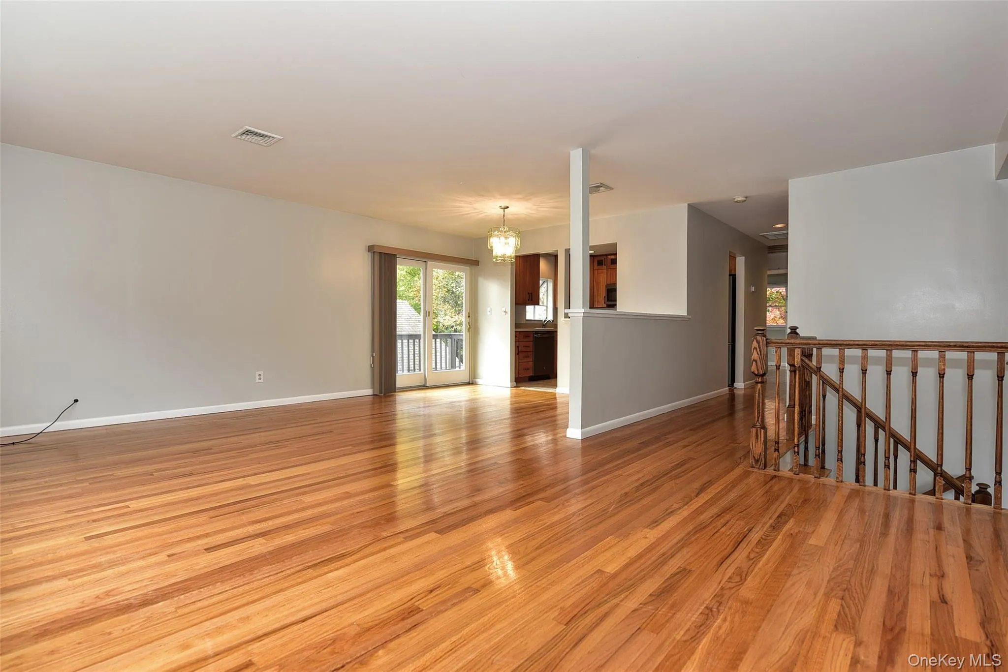 Empty room featuring plenty of natural light and light wood finished floors Empty room featuring plenty of natural light and light wood finished floors