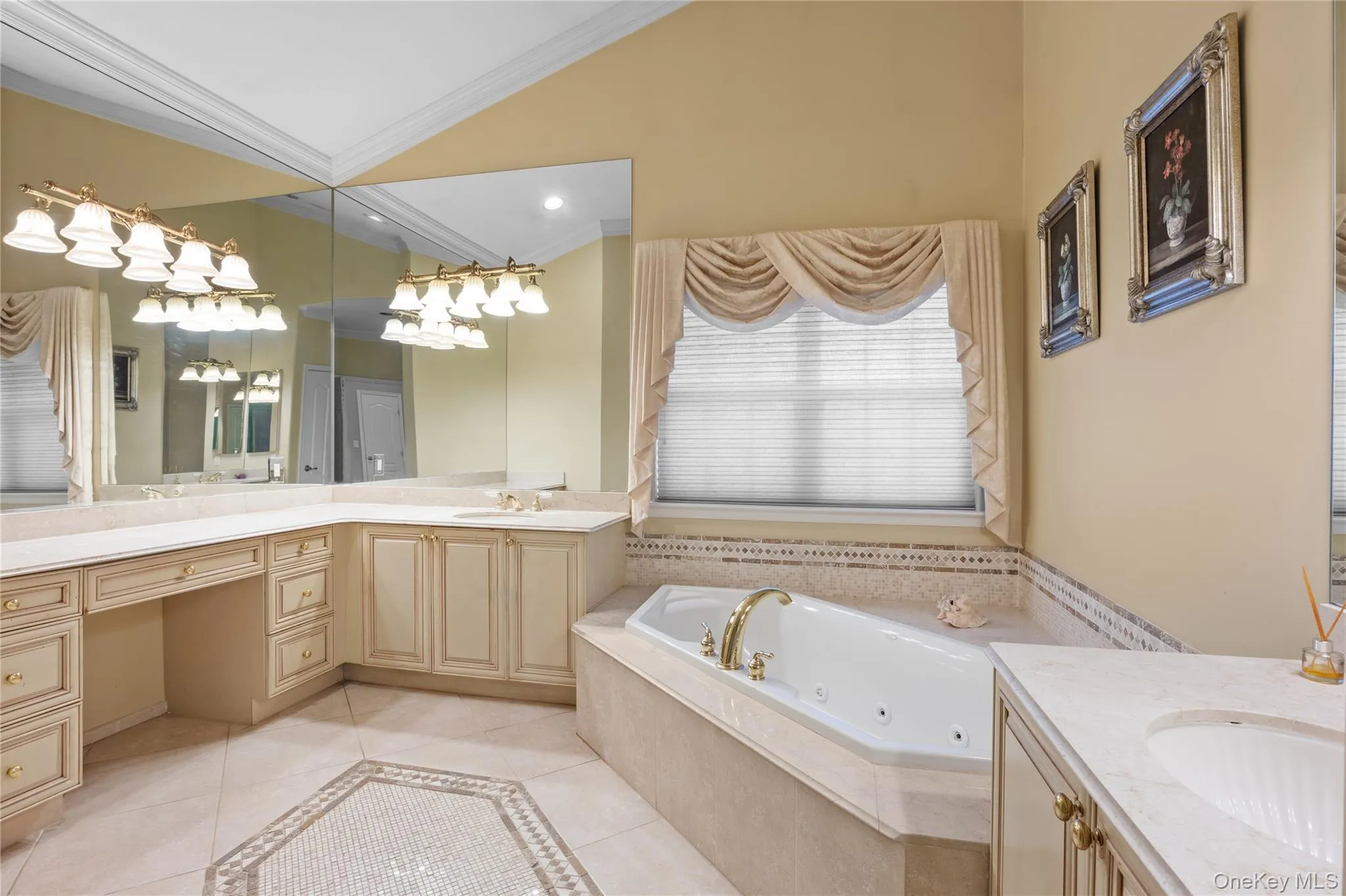 Bathroom with two vanities, light tile patterned floors, a tub with jets, crown molding, and vaulted ceiling Bathroom with two vanities, light tile patterned floors, a tub with jets, crown molding, and vaulted ceiling