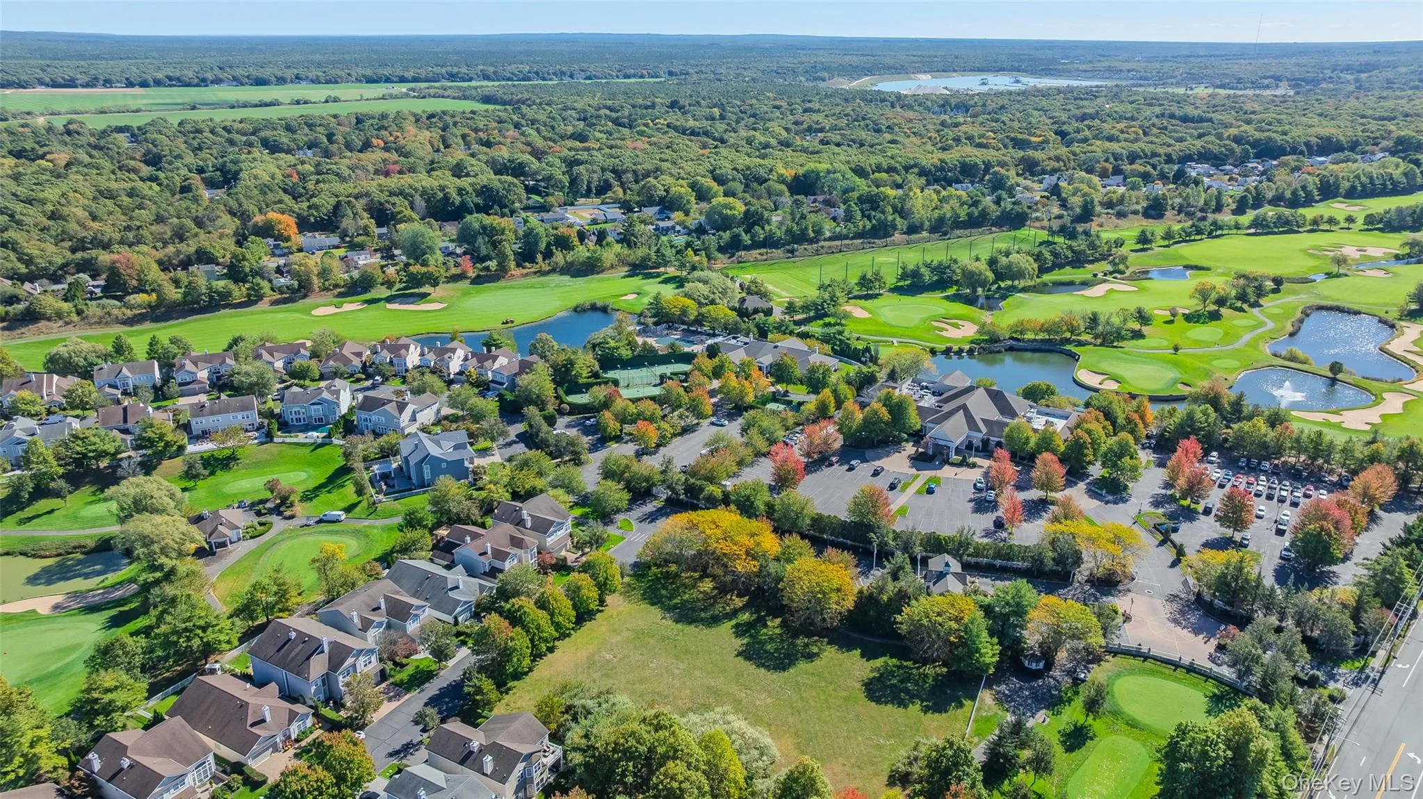 Drone / aerial view of a golf club and a large body of water Drone / aerial view of a golf club and a large body of water