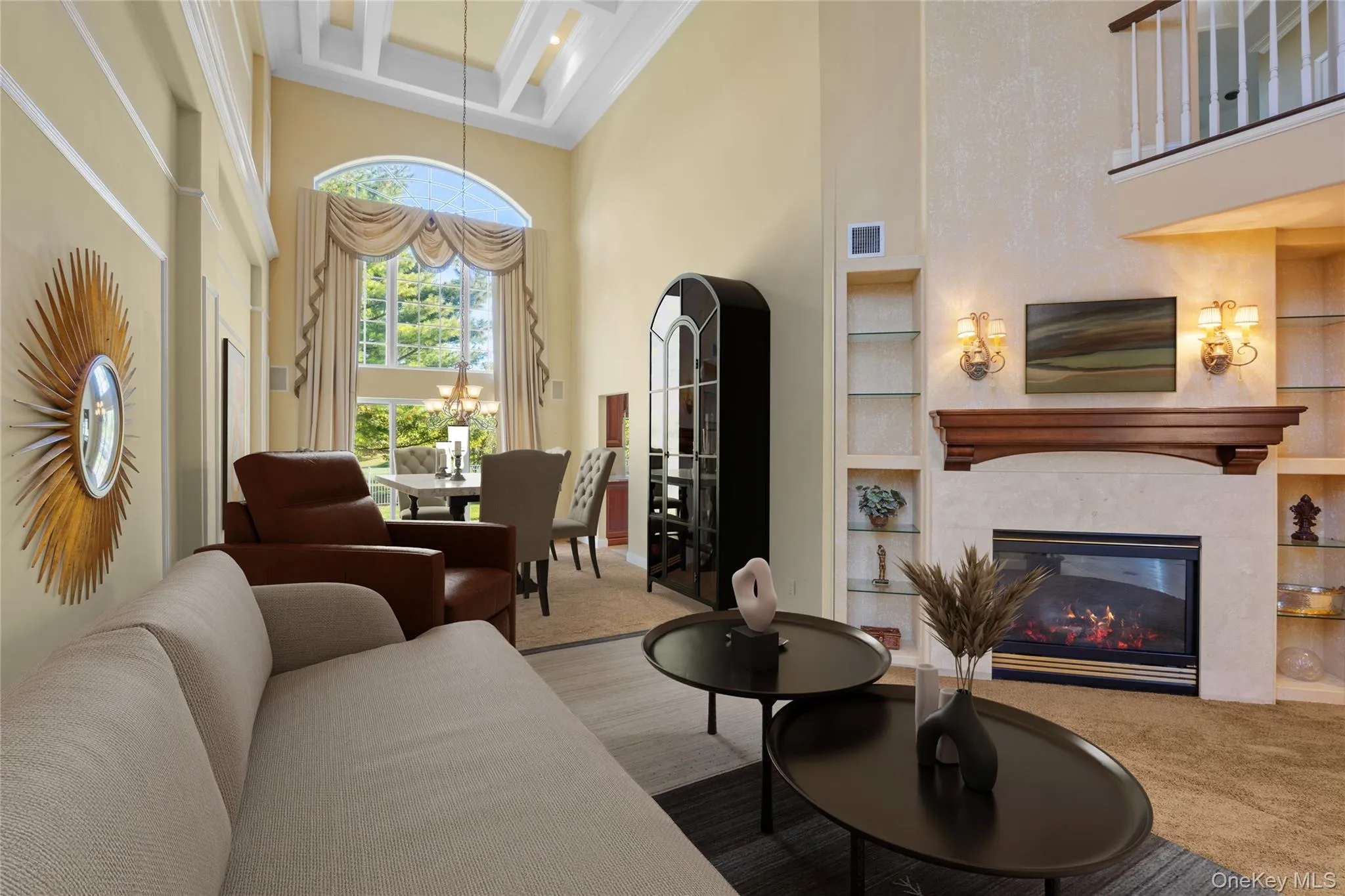 Living room with a high ceiling, built in features, a high end fireplace, coffered ceiling, and beam ceiling Living room with a high ceiling, built in features, a high end fireplace, coffered ceiling, and beam ceiling