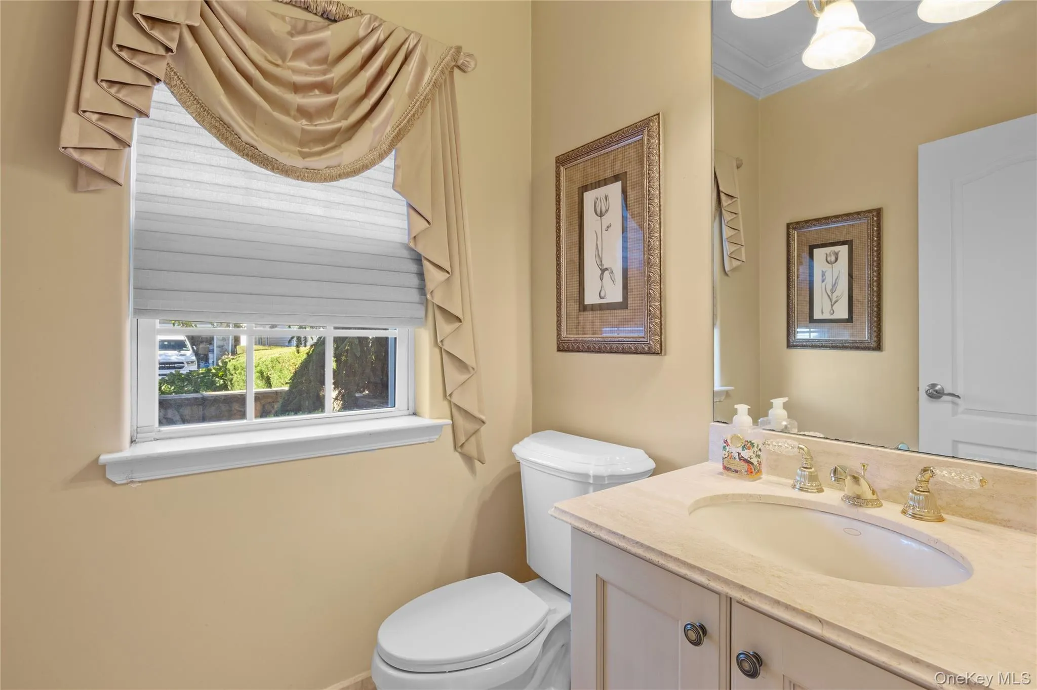 Half bathroom featuring vanity and crown molding Half bathroom featuring vanity and crown molding