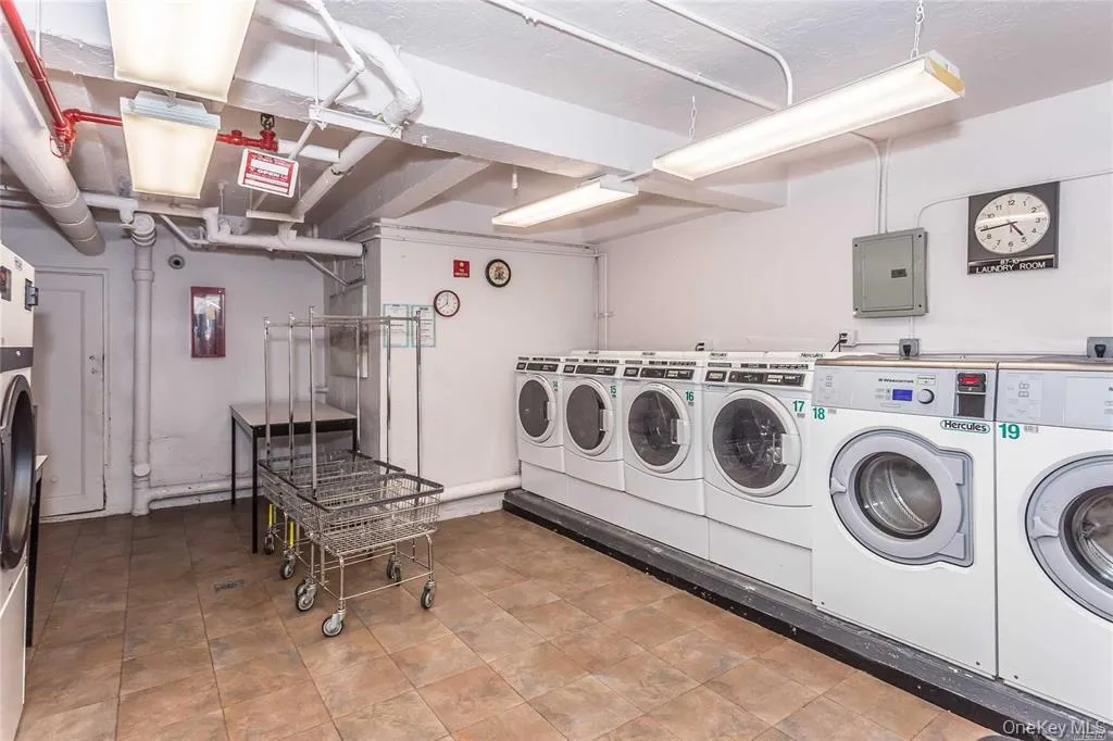 Community laundry room with electric panel and washing machine and dryer Community laundry room with electric panel and washing machine and dryer