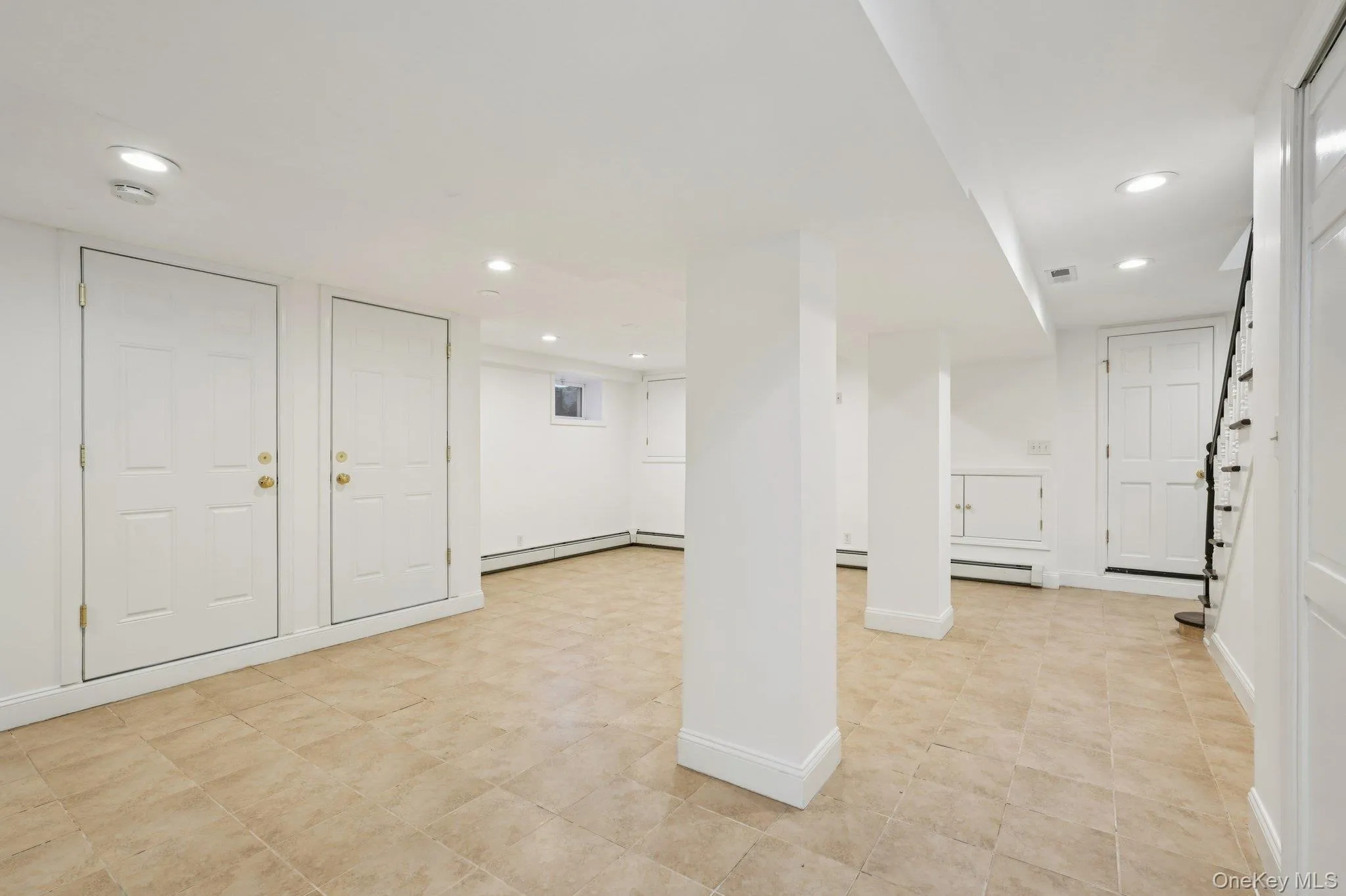 Finished basement with recessed lighting and baseboard heating Finished basement with recessed lighting and baseboard heating