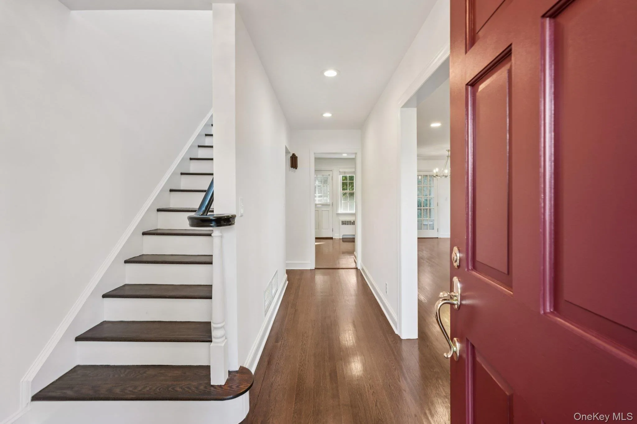 Entrance foyer with recessed lighting, stairway, and dark wood-type flooring Entrance foyer with recessed lighting, stairway, and dark wood-type flooring