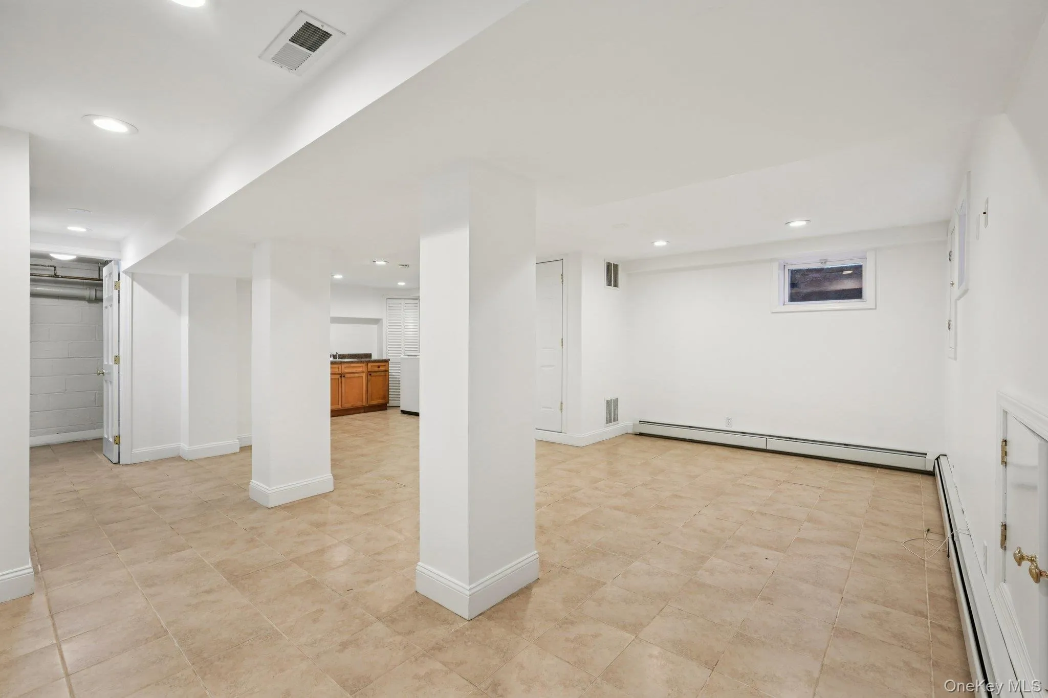 Finished basement with baseboard heating and recessed lighting Finished basement with baseboard heating and recessed lighting