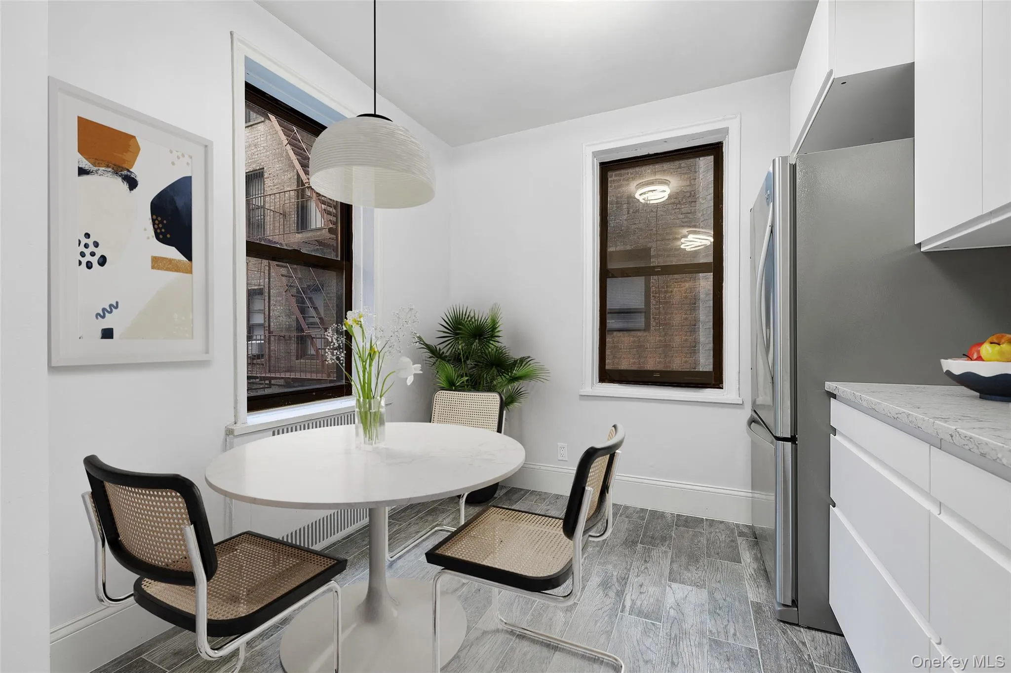 Dining room featuring wood tiled floors and baseboards Dining room featuring wood tiled floors and baseboards