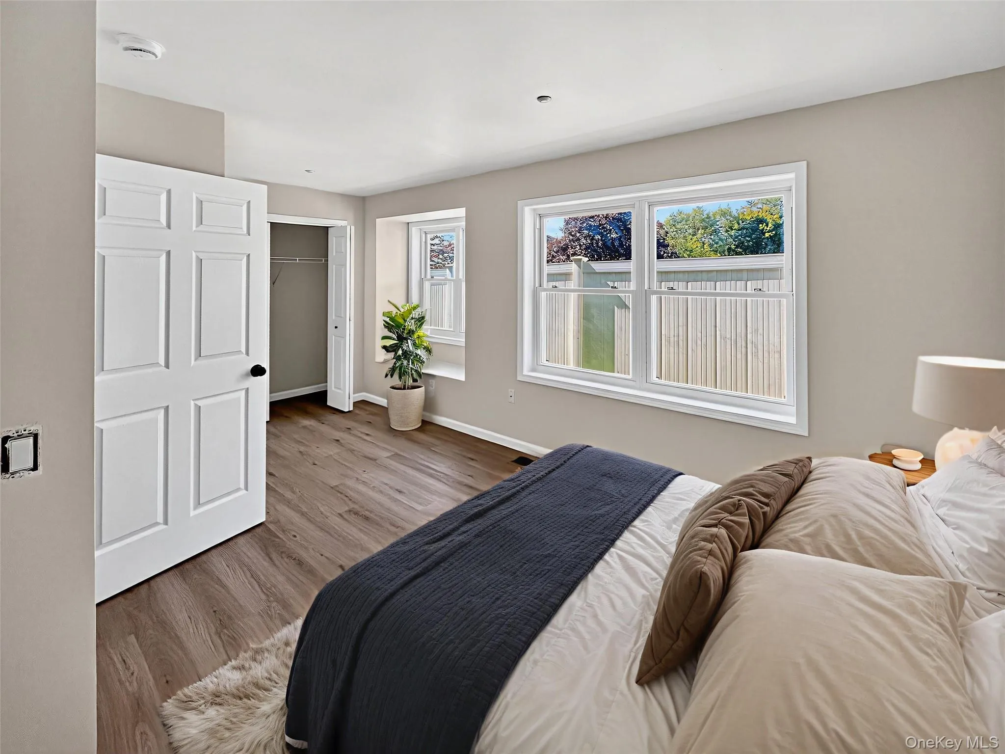 Bedroom featuring wood finished floors and a closet Bedroom featuring wood finished floors and a closet