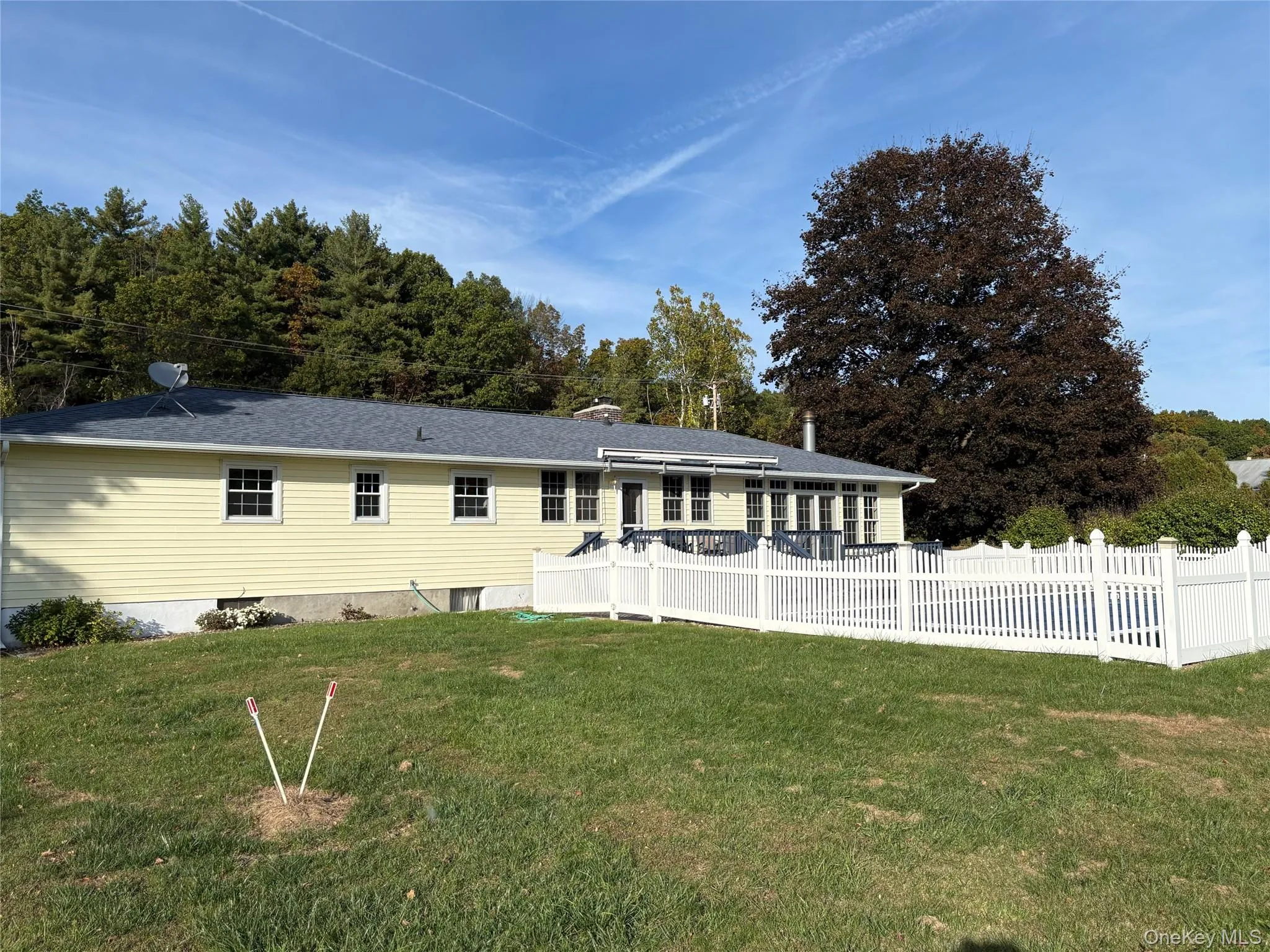 Rear view of house featuring a chimney Rear view of house featuring a chimney