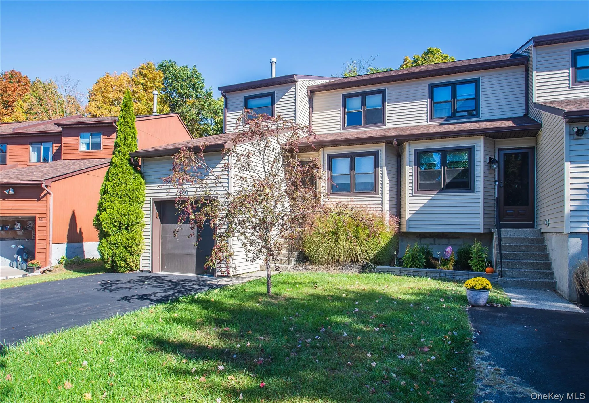 View of front of property featuring asphalt driveway and a front lawn View of front of property featuring asphalt driveway and a front lawn