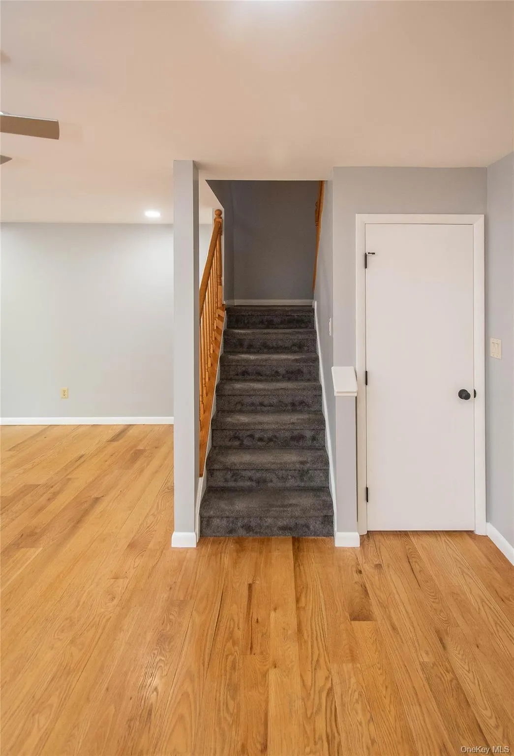 Stairs with baseboards and wood finished floors Stairs with baseboards and wood finished floors