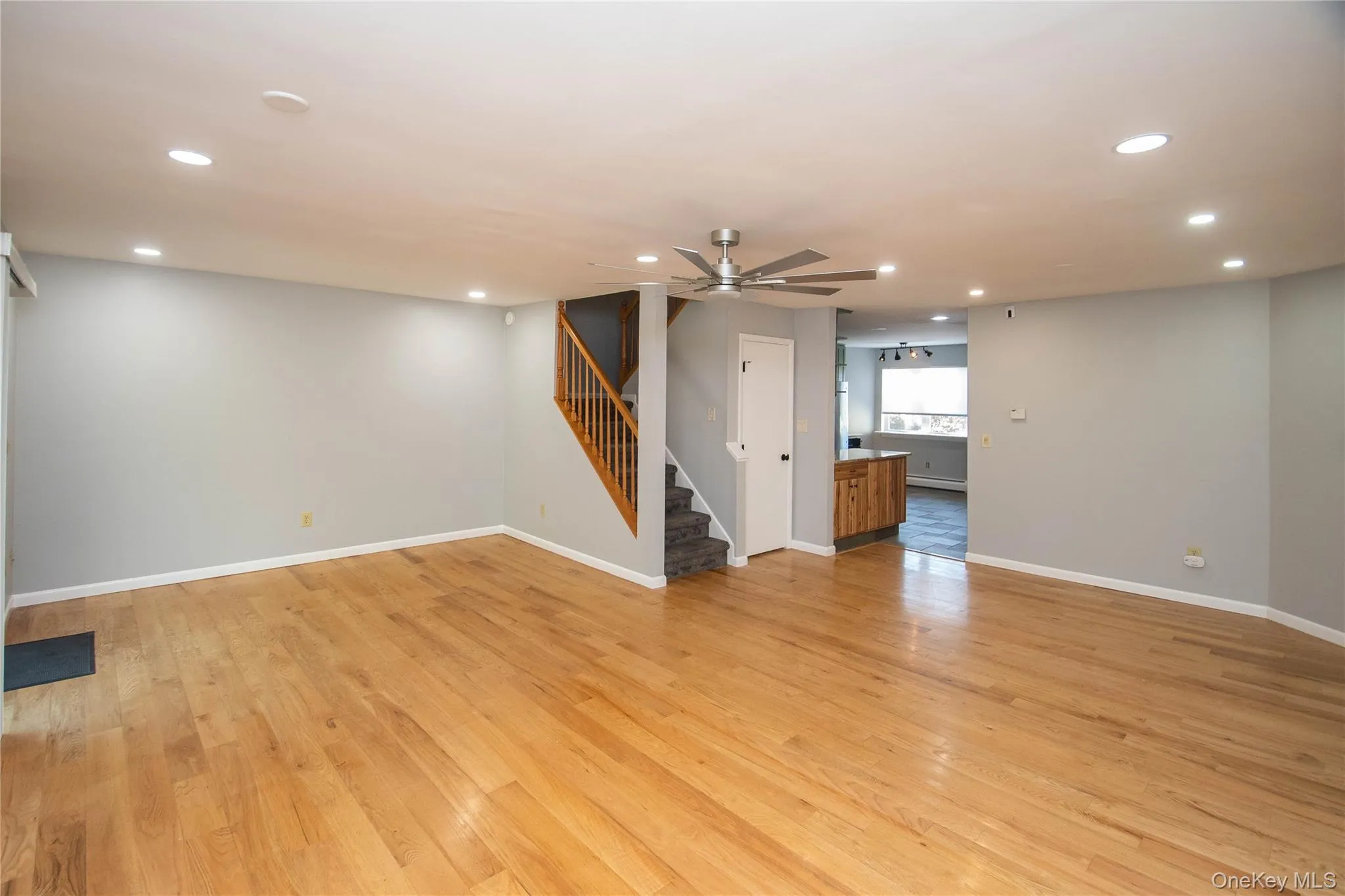 Unfurnished living room with recessed lighting, stairway, light wood-style flooring, and ceiling fan Unfurnished living room with recessed lighting, stairway, light wood-style flooring, and ceiling fan