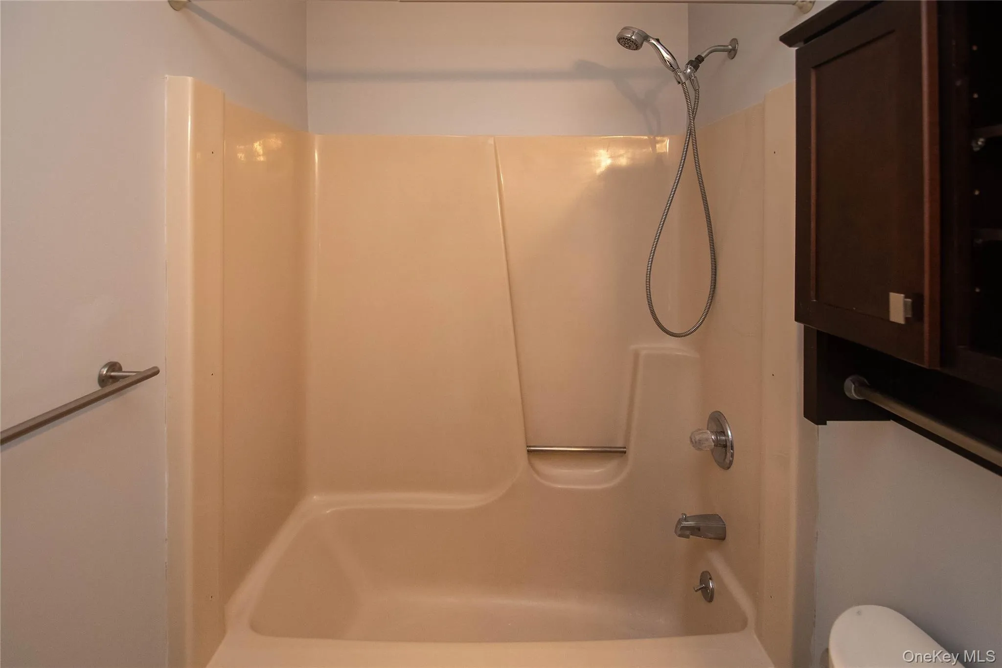 Bathroom with shower / bath combination and toilet Bathroom with shower / bath combination and toilet