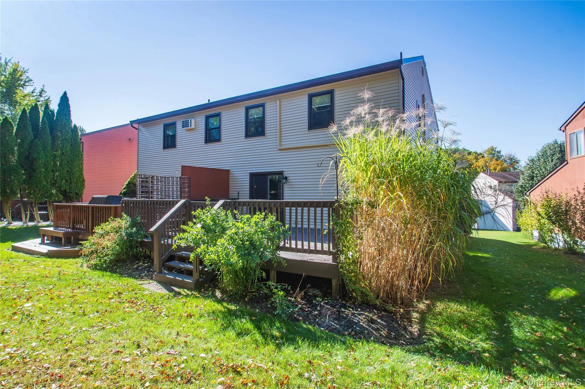 Back of property featuring a lawn and a deck Back of property featuring a lawn and a deck