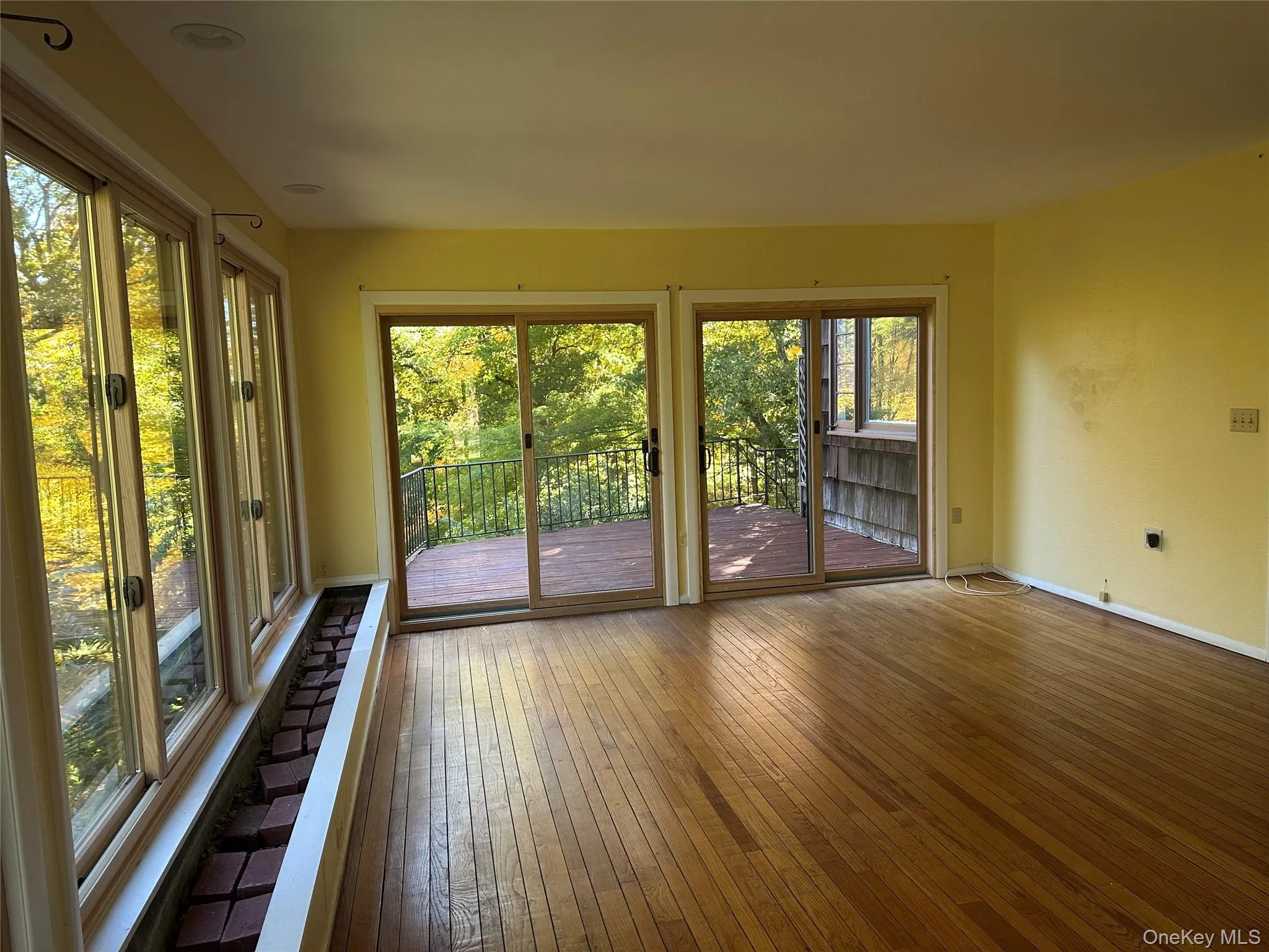 Doorway to outside with wood-type flooring and baseboards Doorway to outside with wood-type flooring and baseboards