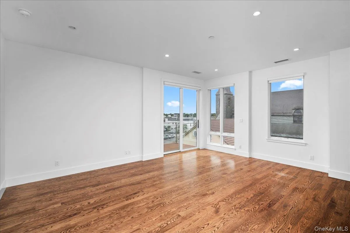 Living room featuring plenty of natural light, wood finished floors, and recessed lighting Living room featuring plenty of natural light, wood finished floors, and recessed lighting