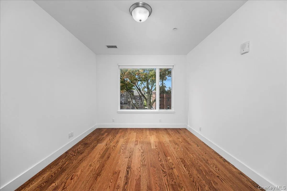 Bedroom with wood finished floors and baseboards Bedroom with wood finished floors and baseboards