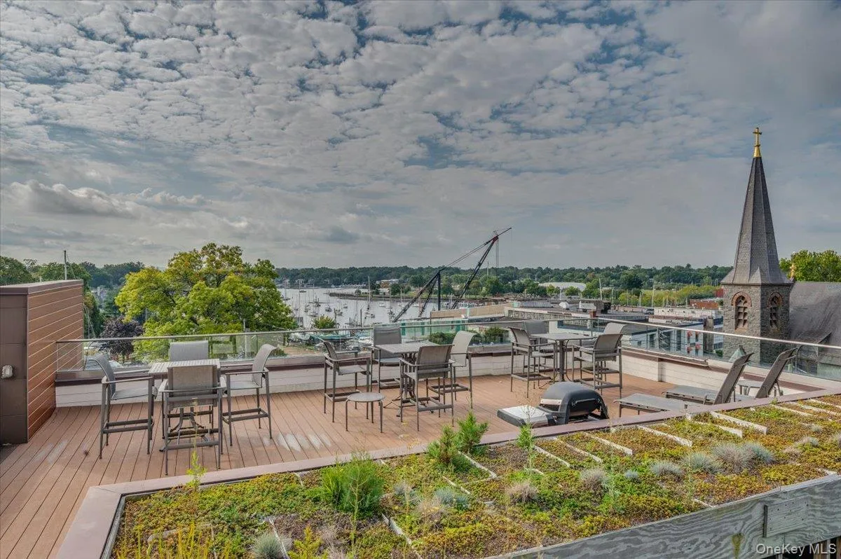 Wooden terrace featuring outdoor dining area and area for grilling Wooden terrace featuring outdoor dining area and area for grilling