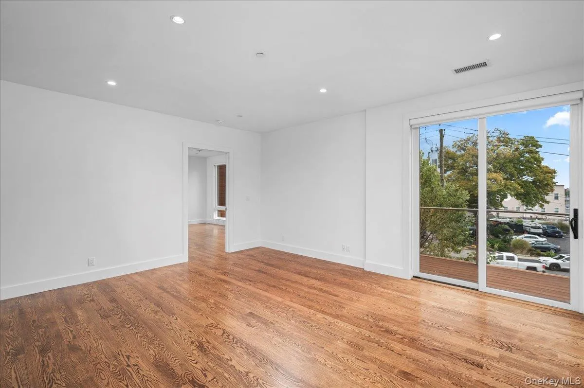 Living room with recessed lighting and light wood-type flooring Living room with recessed lighting and light wood-type flooring