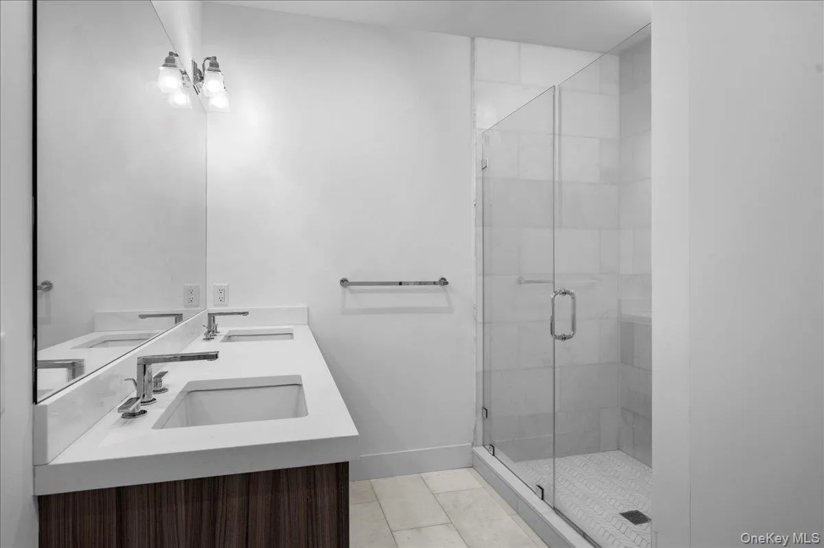 Master full bath with a stall shower, light tile patterned floors, and double vanity Master full bath with a stall shower, light tile patterned floors, and double vanity